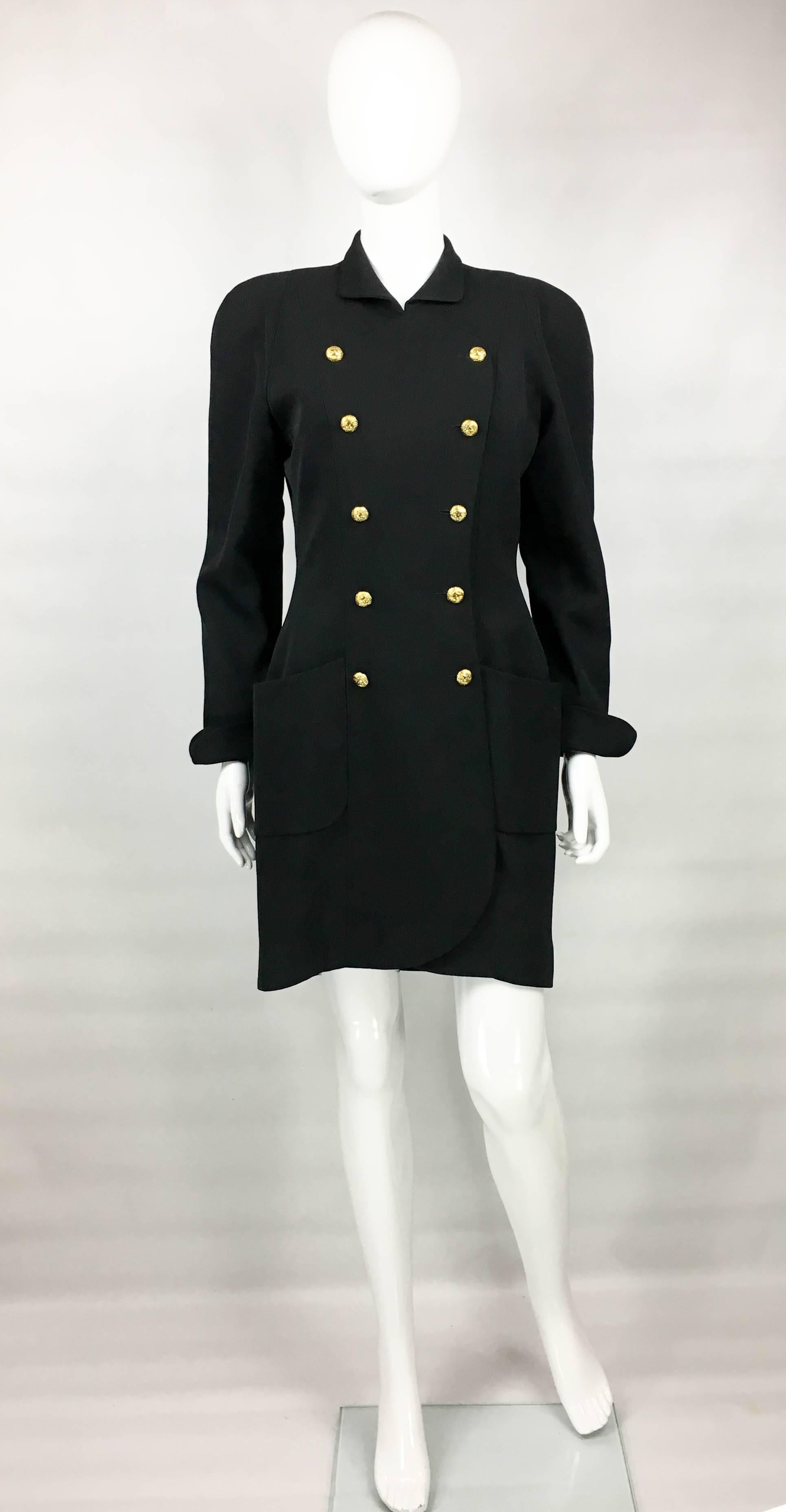 Vintage Chanel Black Wool Dress / Coat. This beautiful piece by Chanel dates back from the early 1990’s. It can be worn as dress or a coat. Made in wool gabardine, it is double-breasted and lined in silk. The buttons are gilded and show a quilted