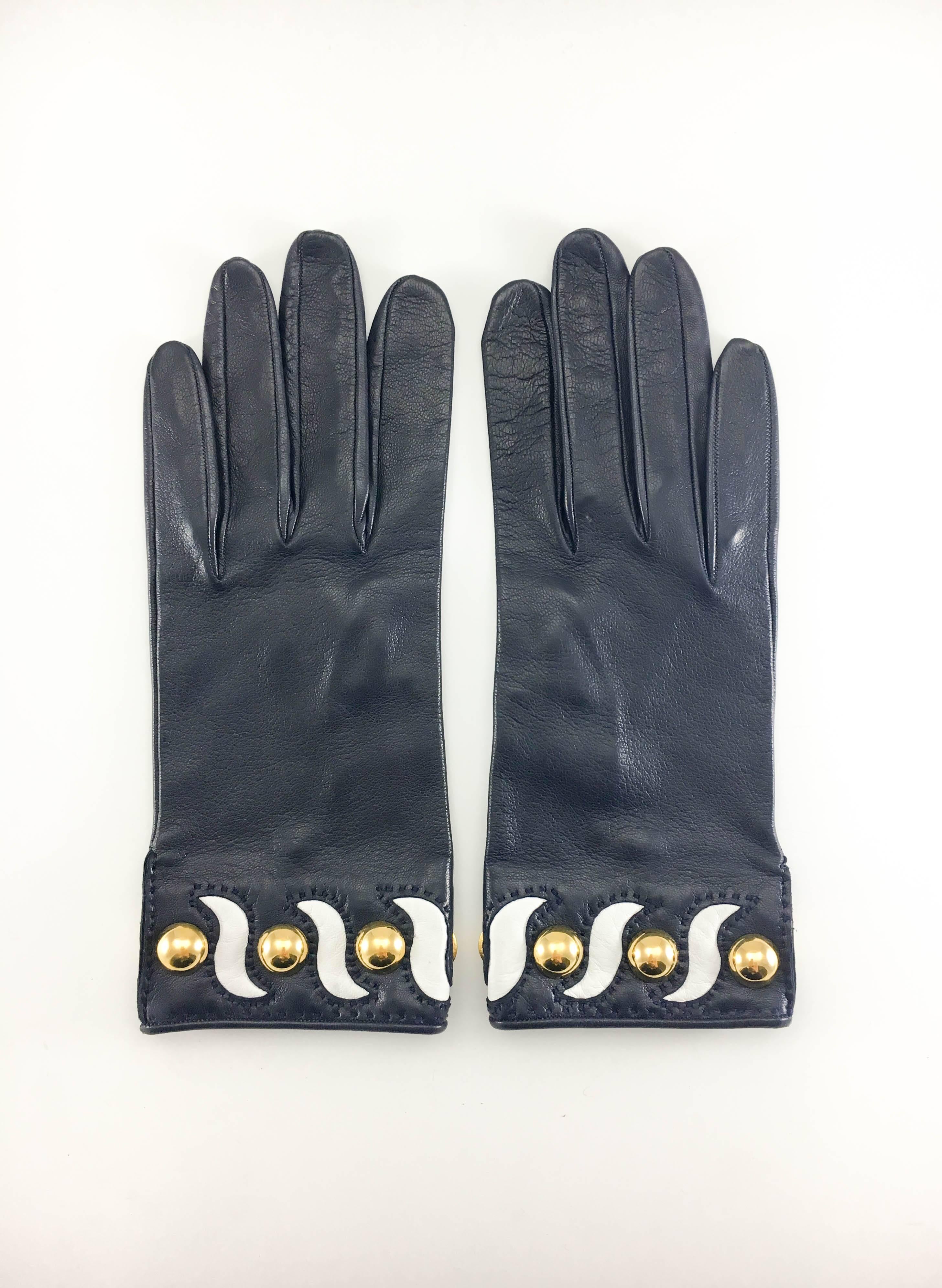 These very stylish gloves by Hermes are made in navy blue leather and feature white leather waves and gilt studs pattern to the wrist. So chic!

Label / Designer: Hermes

Period: 21st Century

Origin: France

Materials: Leather; Gilt Metal
