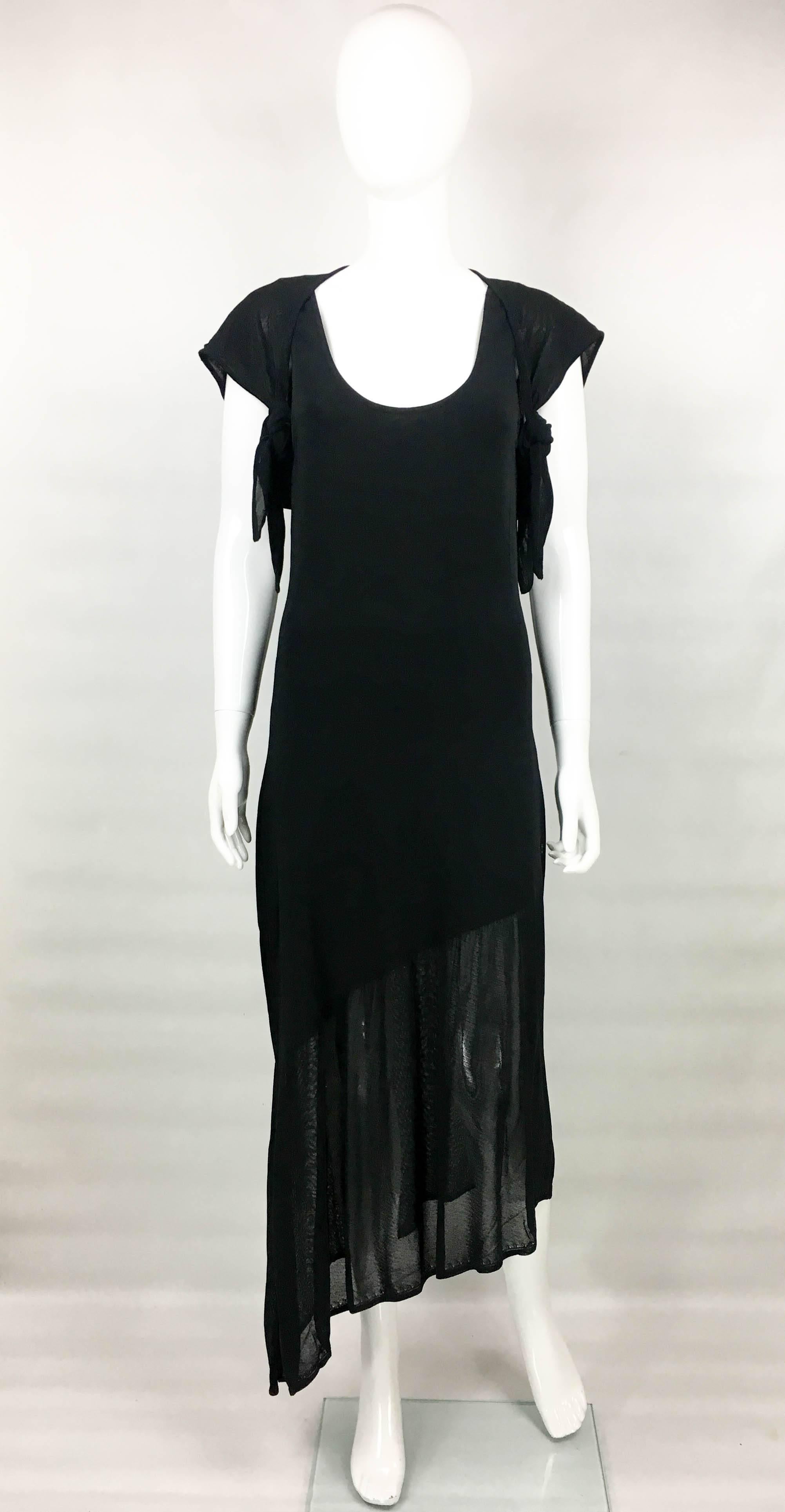Vintage Chanel Asymmetrical Black Dress. This stylish dress dates back from 2002. For this collection Karl Lagerfeld’s inspiration was dance and ballet (one of Coco Chanel’s passions). Sleeveless and loose-fitting, it features an asymmetrical