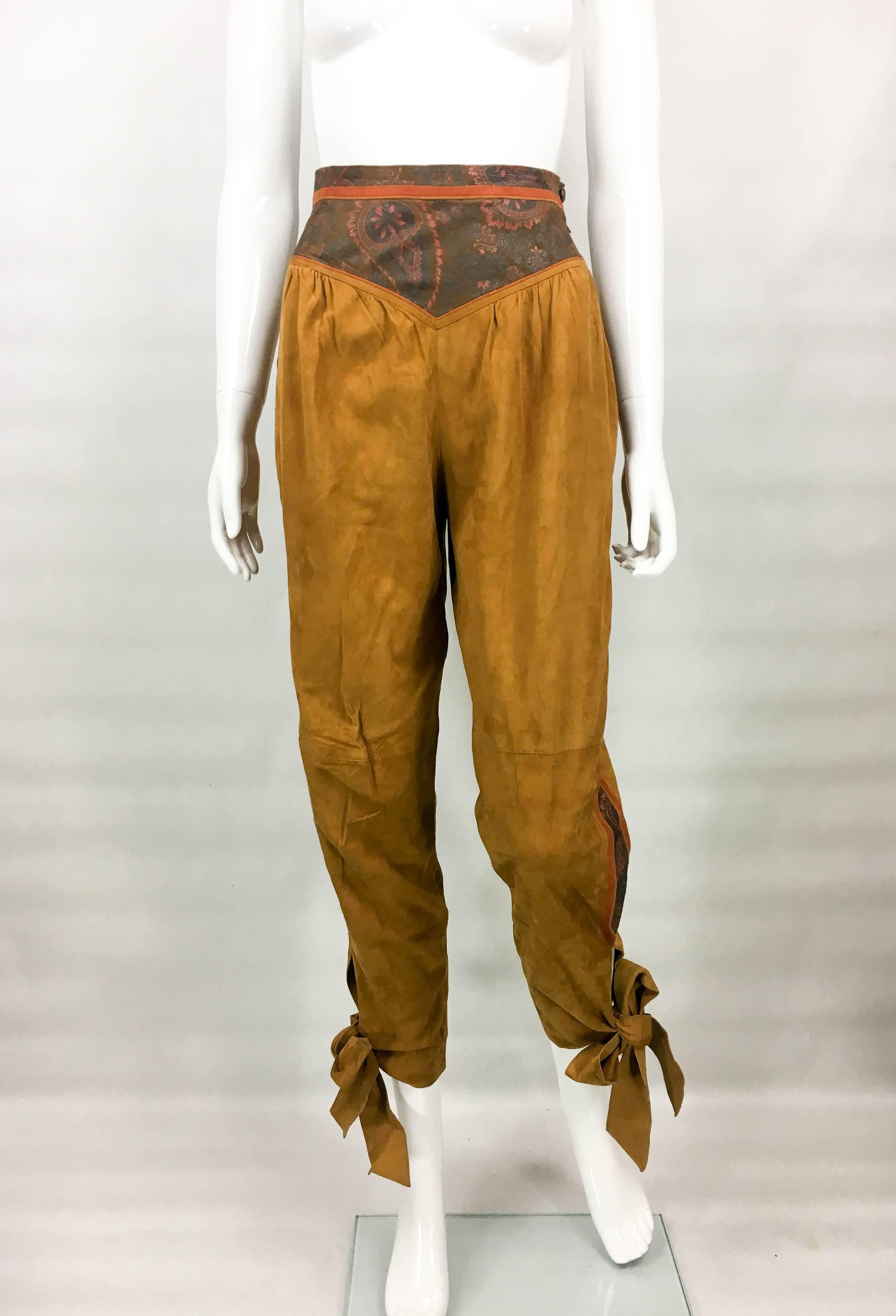 Vintage Roberto Cavalli Brown Suede Cropped Trousers. These very stylish trousers by Roberto Cavalli date back from the 1980’s. High-waisted, they are made in camel suede and feature painted leather panels on the waist and down the sides. A striking