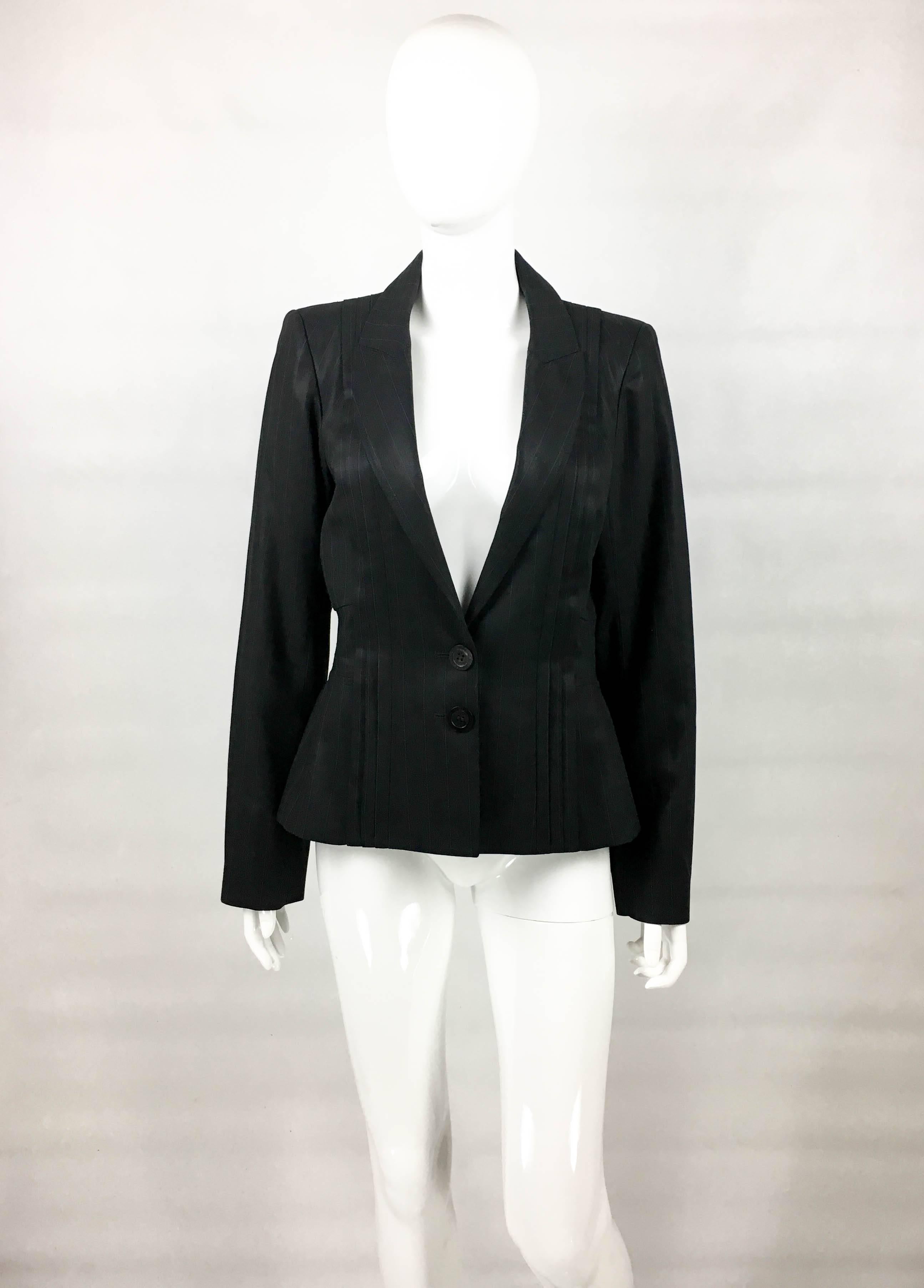 Dior by Galliano Pinstripe Pleated Jacket. This very stylish jacket by Dior was designed for the 2005 Spring / Summer collection. Made in light black wool pinstripe, it features pleats down the front and back. Also, there is panelling to the waist,