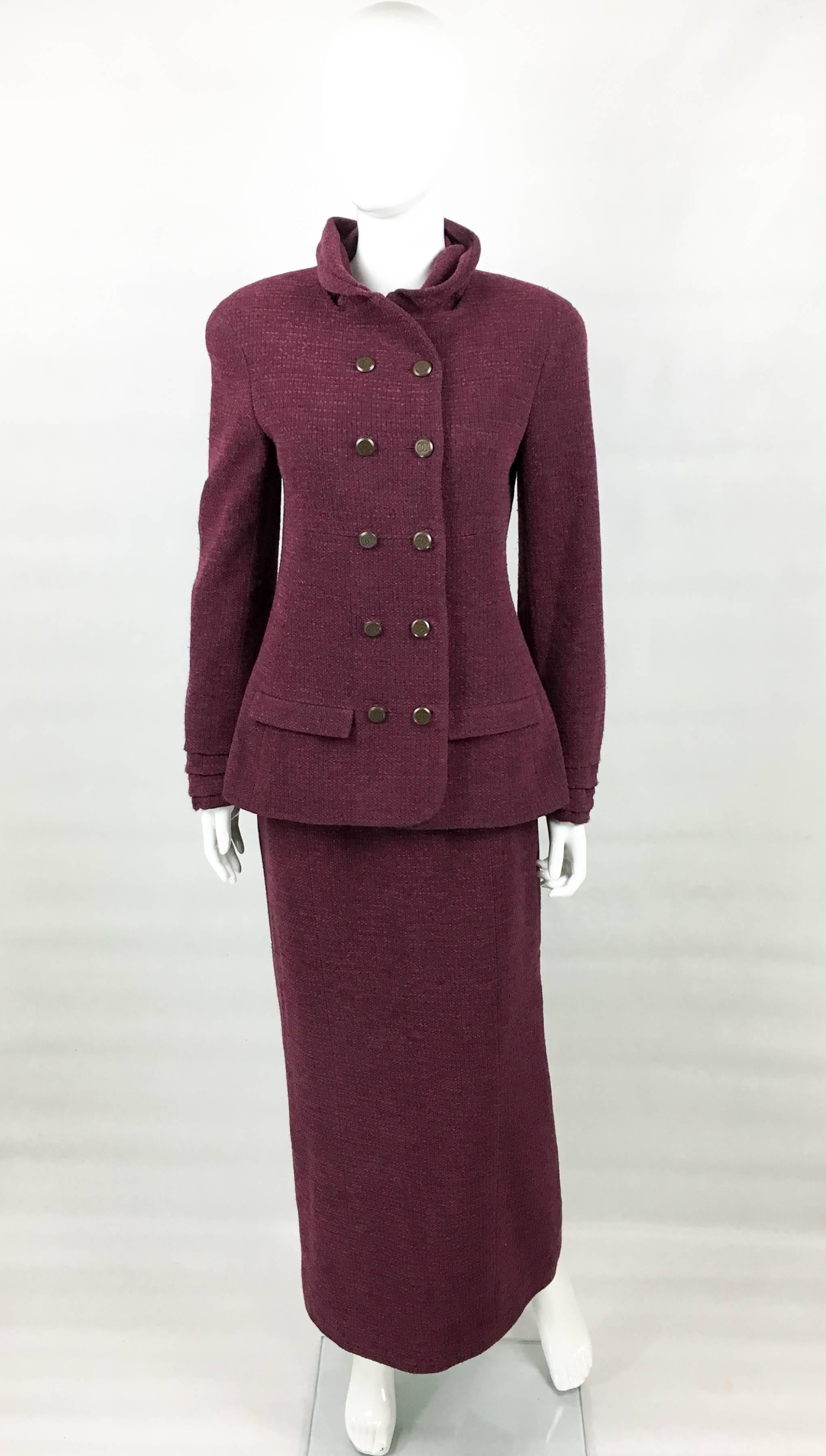 Vintage Chanel Burgundy Long Skirt Suit. This very elegant suit by Chanel is from the 1998 Autumn / Winter Collection. Made in burgundy wool bouclé, it consists of a jacket and a long skirt. The double-breasted jacket has a cowl neck and pleating