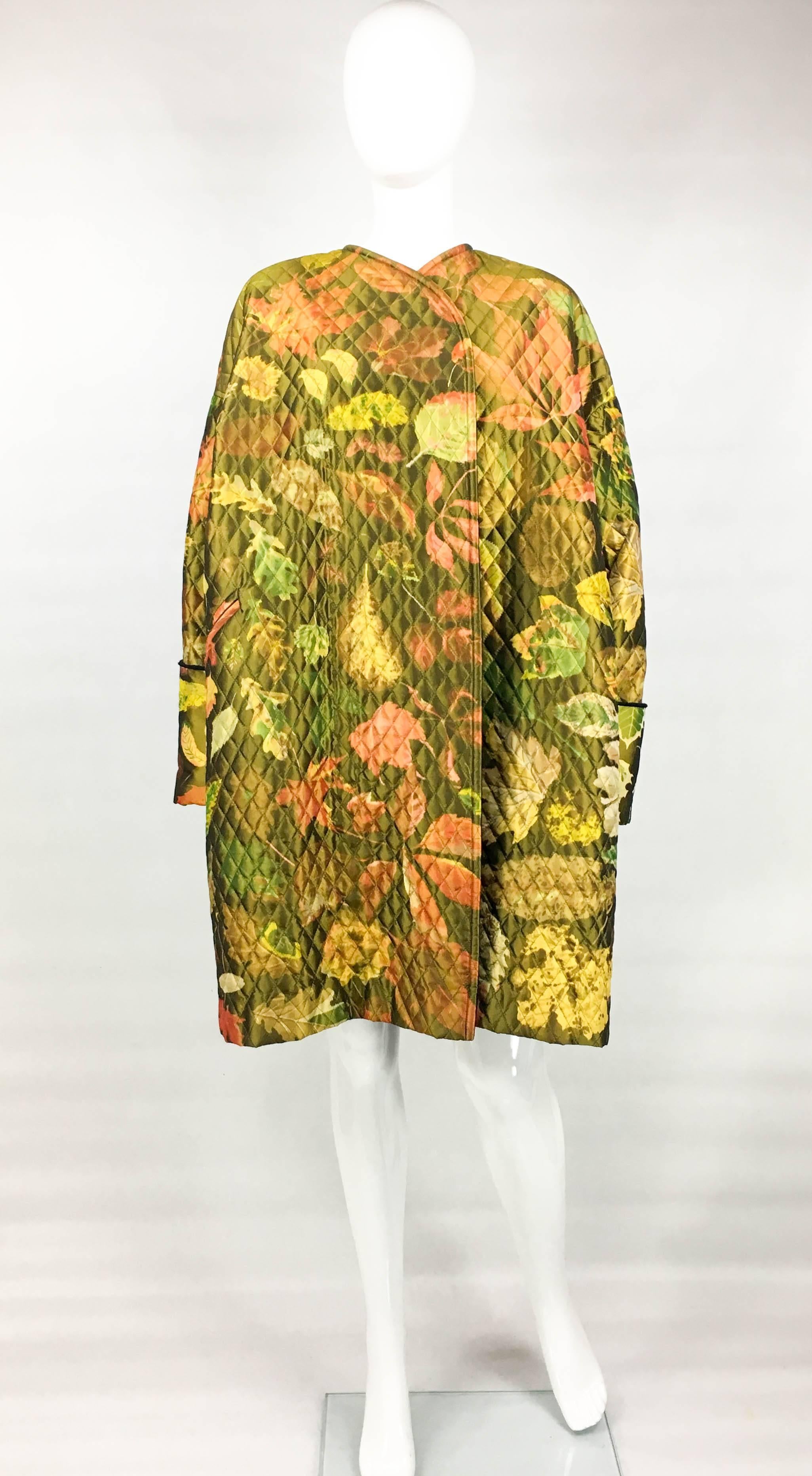Vintage Hermes Printed Silk Coat. This stunning coat by Hermes dates back from the 1980’s. It is made in printed silk in autumnal shades with foliage pattern. The oversized open-closure coat is quilted and lined in black cashmere fleece. A fabulous