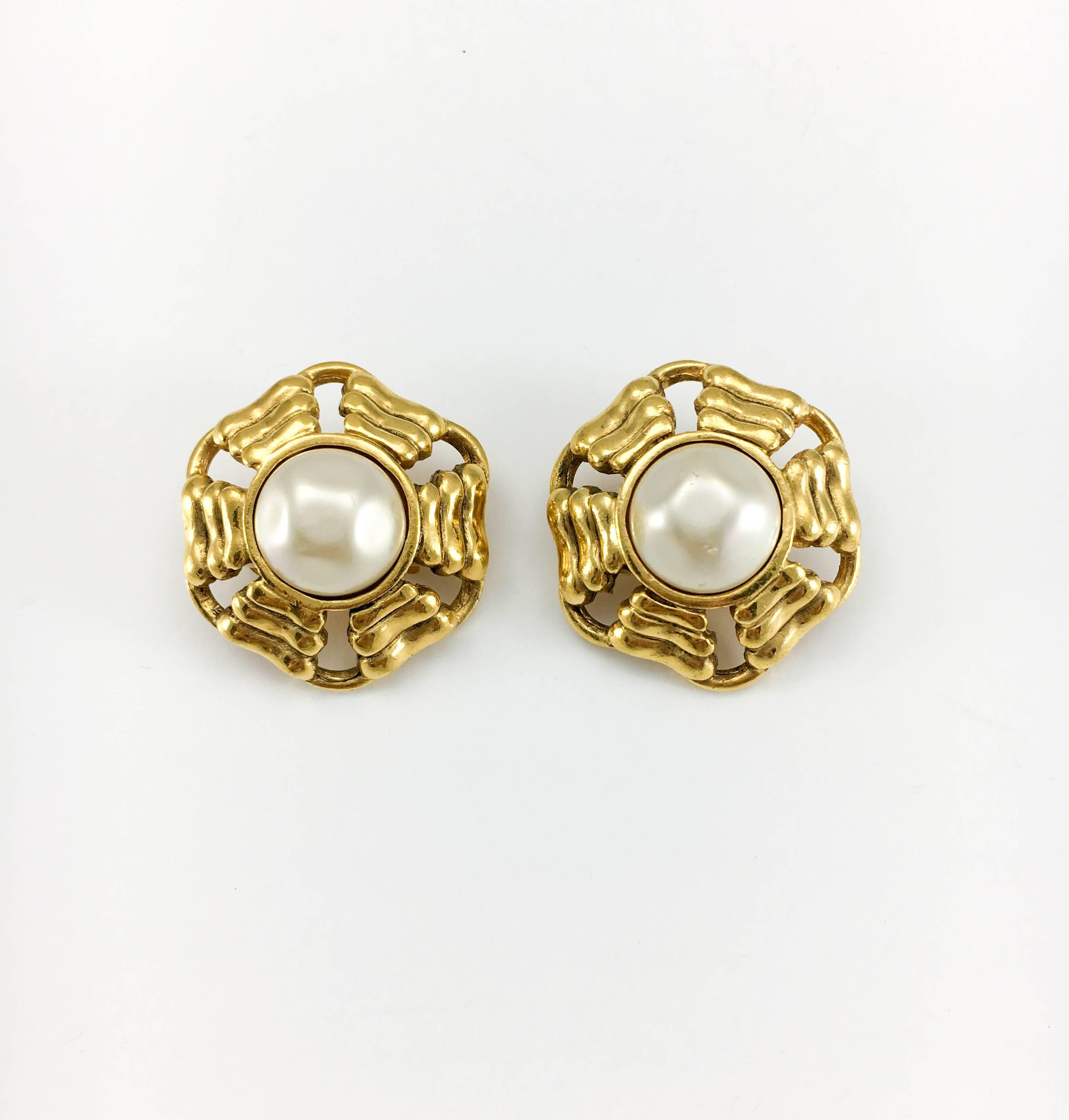 Vintage Chanel Pearl Gold-Plated Clip-on Earrings. A pair of Chanel earrings dating back from the 1980’s. Gold-plated, the round design is complimented by a faux pearl cabochon in the centre. Chanel signed on the back. Bringing the class and style