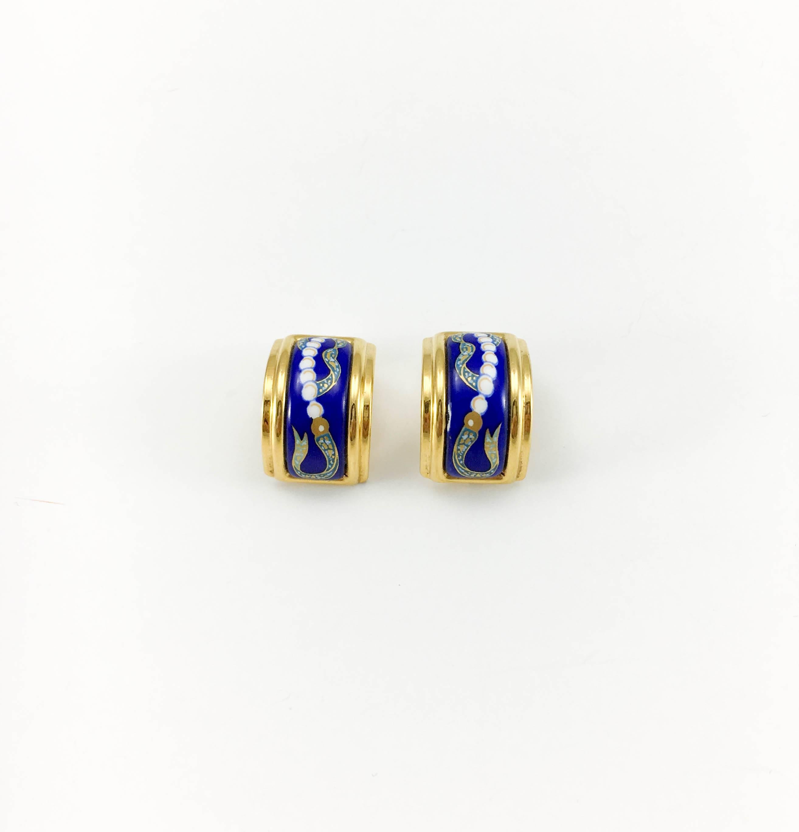 Vintage Hermes Enamelled Clip-On Earrings. These fun and stylish earrings by Hermes date back from the 1990’s. They are made in gold-plated metal and enamel in shades of blue, white, green and golden. They are curved and feature an oriental inspired