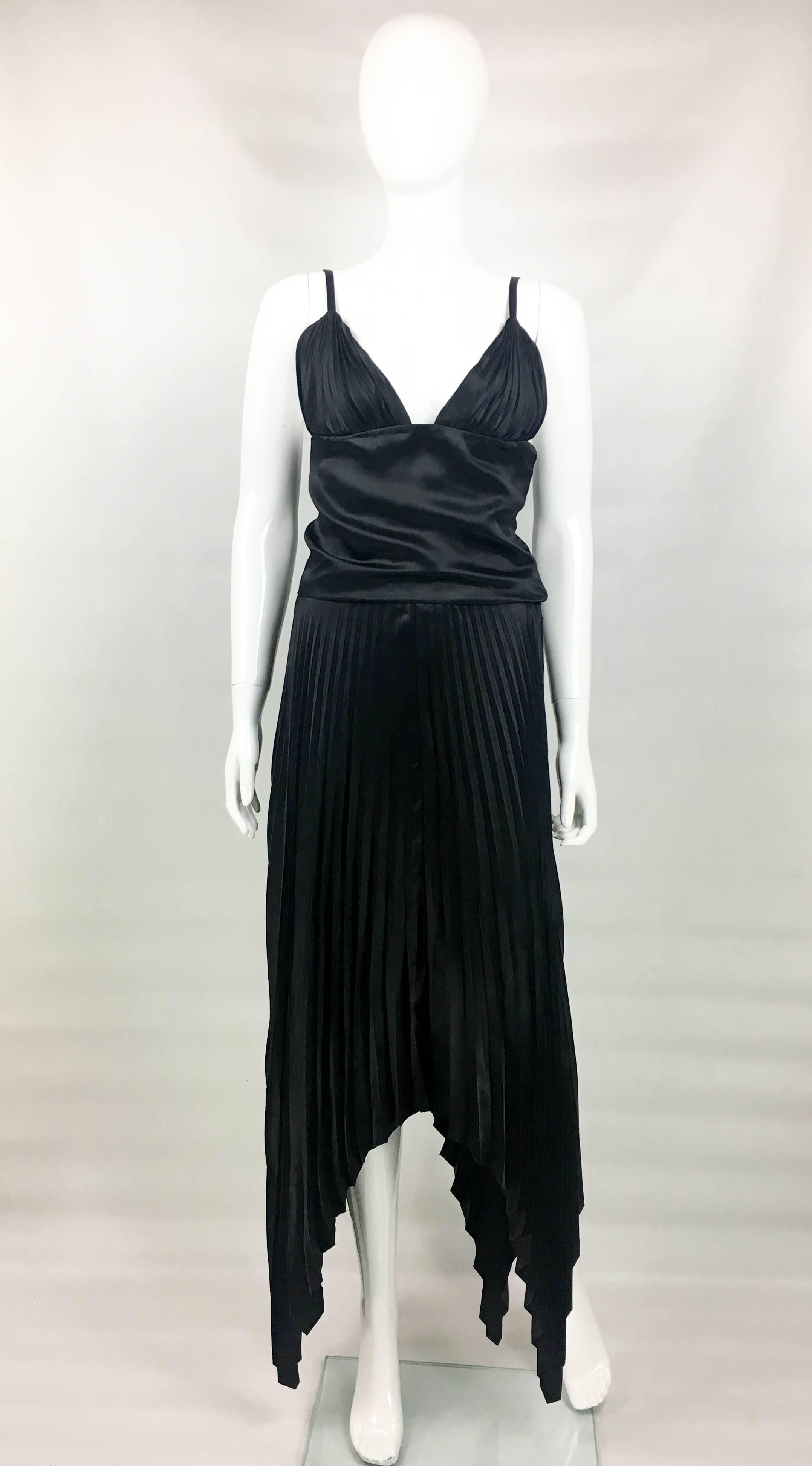 Vintage Dior Haute Couture Black Silk Pleated Dress. This gorgeous dress by Dior was created by Marc Bohan for the 1983 Spring/Summer Haute Couture Collection. Made in black silk, it features pleated skirt, draped torso and pleated bust. It has