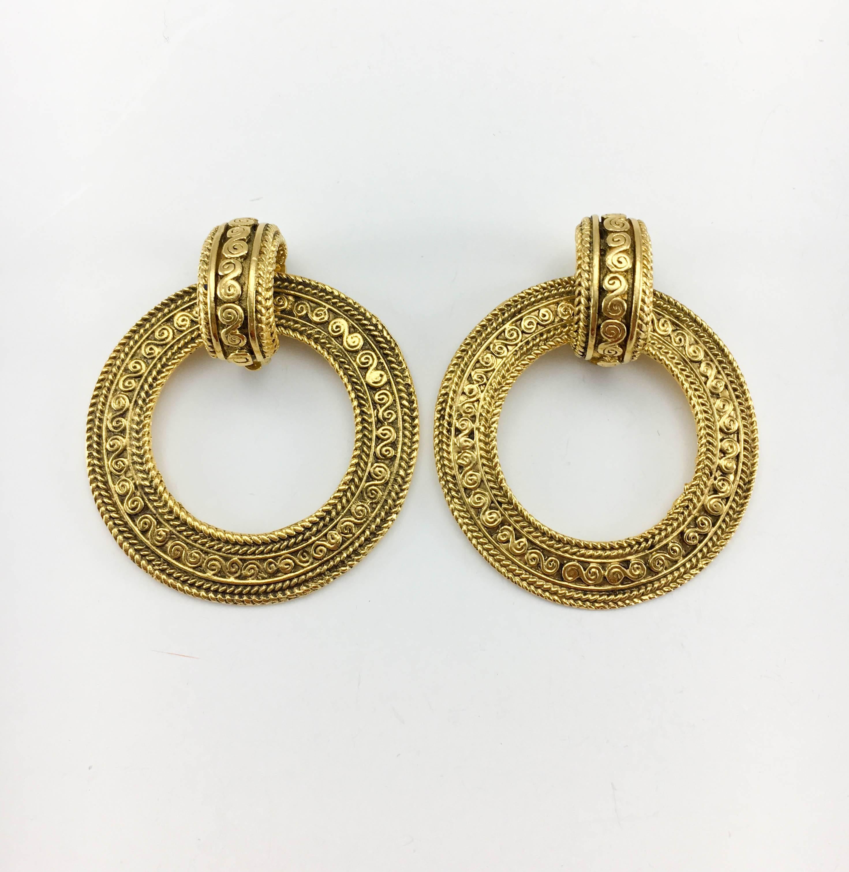 Gorgeous Vintage Chanel Large Hoop Earrings. These amazing earrings by Chanel date back from the 1980’s. Gold-plated, the baroque-inspired design shows intricate details. Versatile, they can be worn as large, statement door-knocker style hoops, or