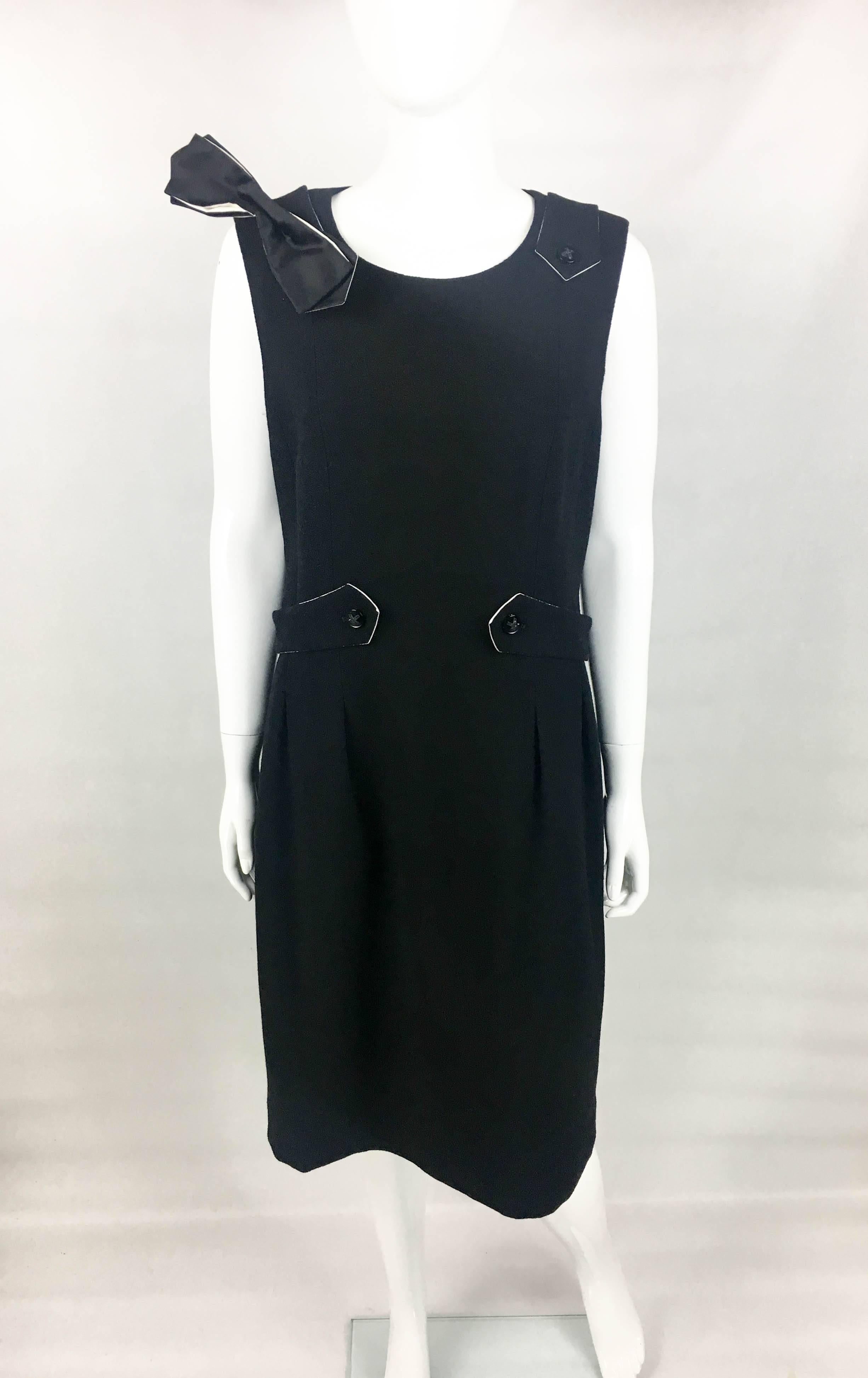 Chanel Runway Look Black Dress With Removable Bow. This elegant sleeveless dress by Chanel was created for the 2006 Autumn / Winter Collection. An identical dress can be seen worn by Daria Werbowy on the runway (please refer to photos). Made in
