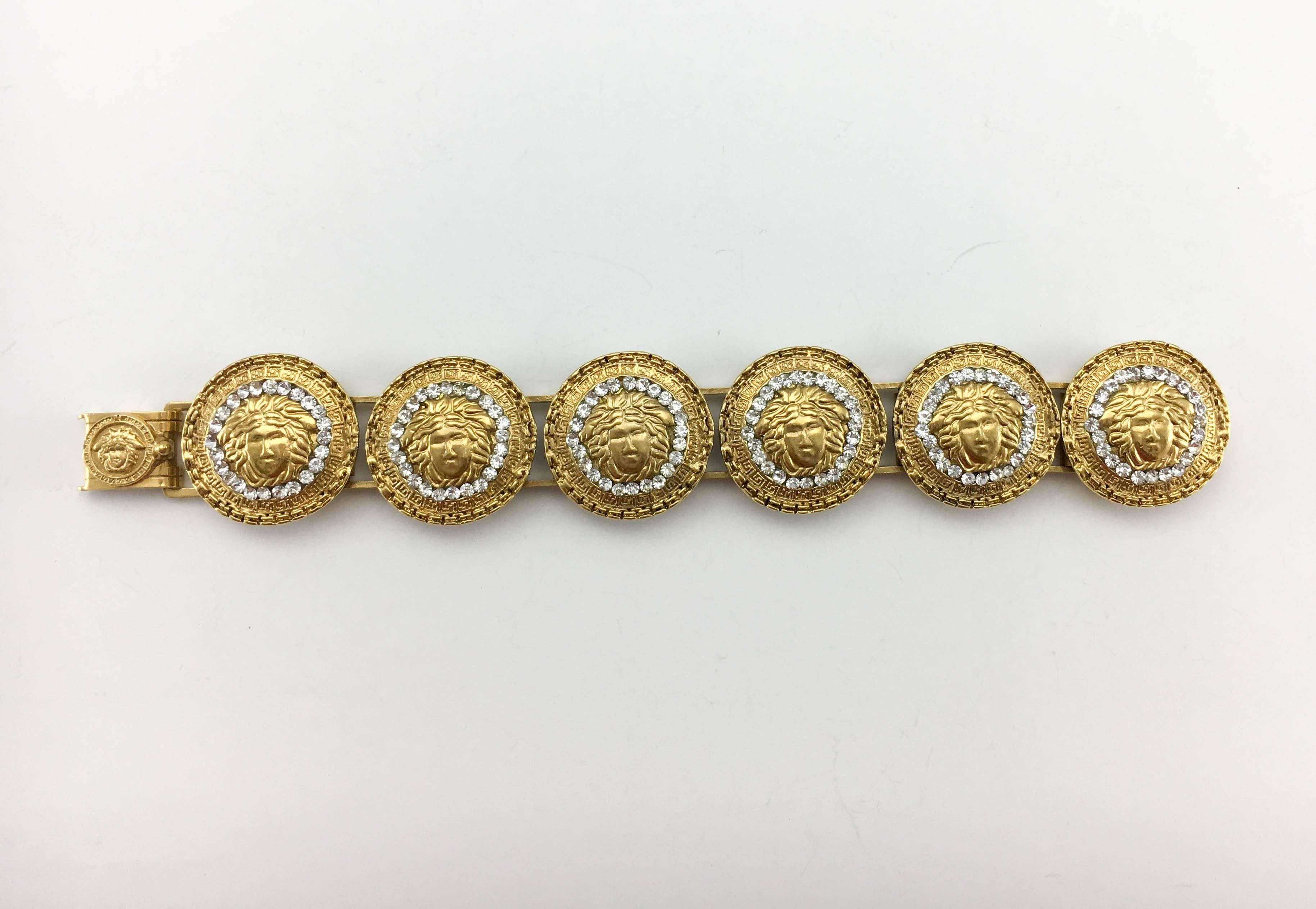 Vintage Gianni Versace Gold-Plated Medusa Head With Rhinestones Bracelet. This gorgeous piece by Versace dates back from the 1990’s, when Gianni Versace himself was still alive. Crafted in gold-plated metal, it has six medallions bearing the iconic