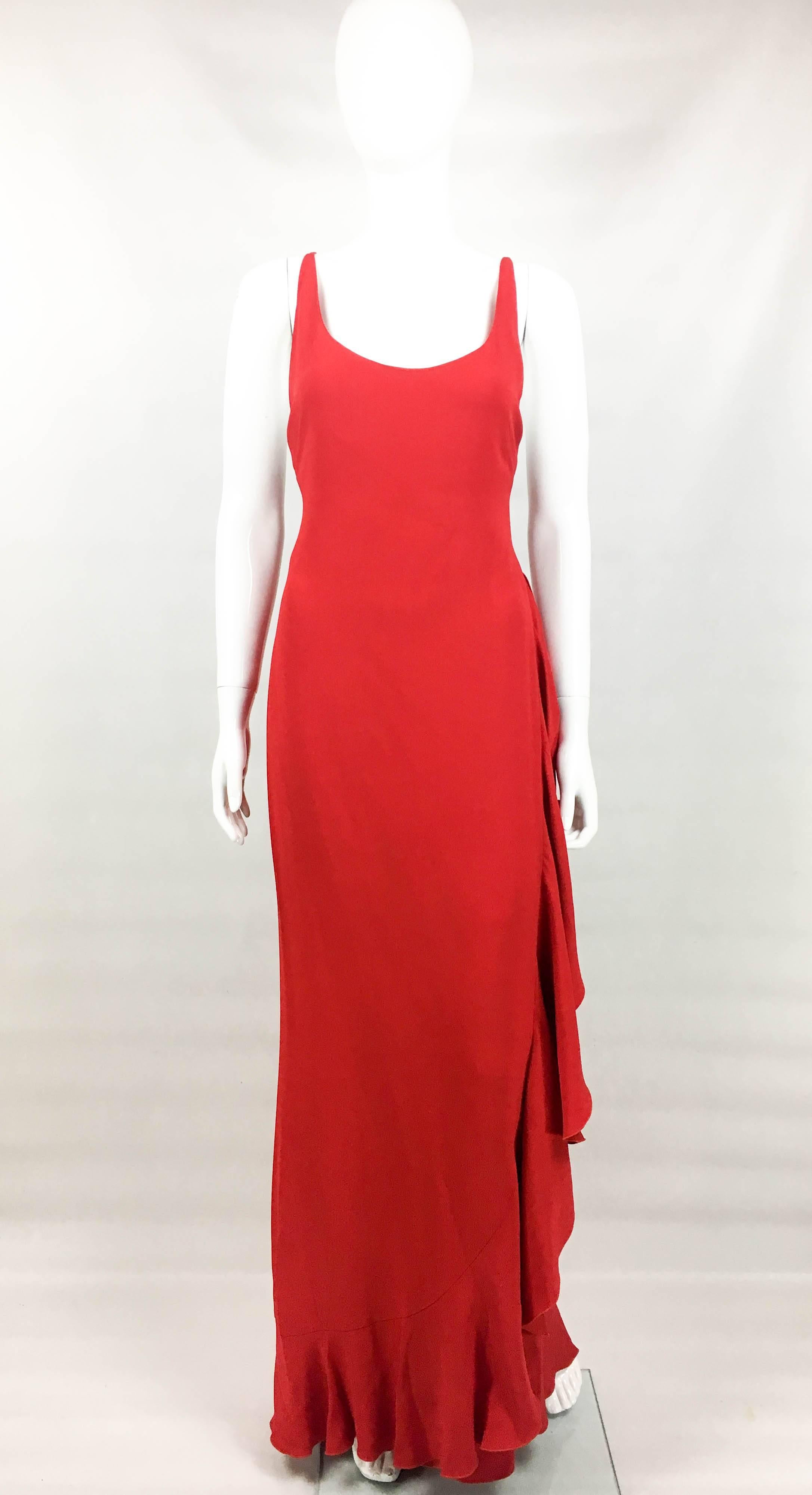 Vintage Valentino Red Evening Gown. This gorgeous dress by Valentino dates back from the 1980’s. Made in red silk, it is flamenco-inspired with a flounce and a cross back. The silhouette is very flattering and it moves beautifully. This dress