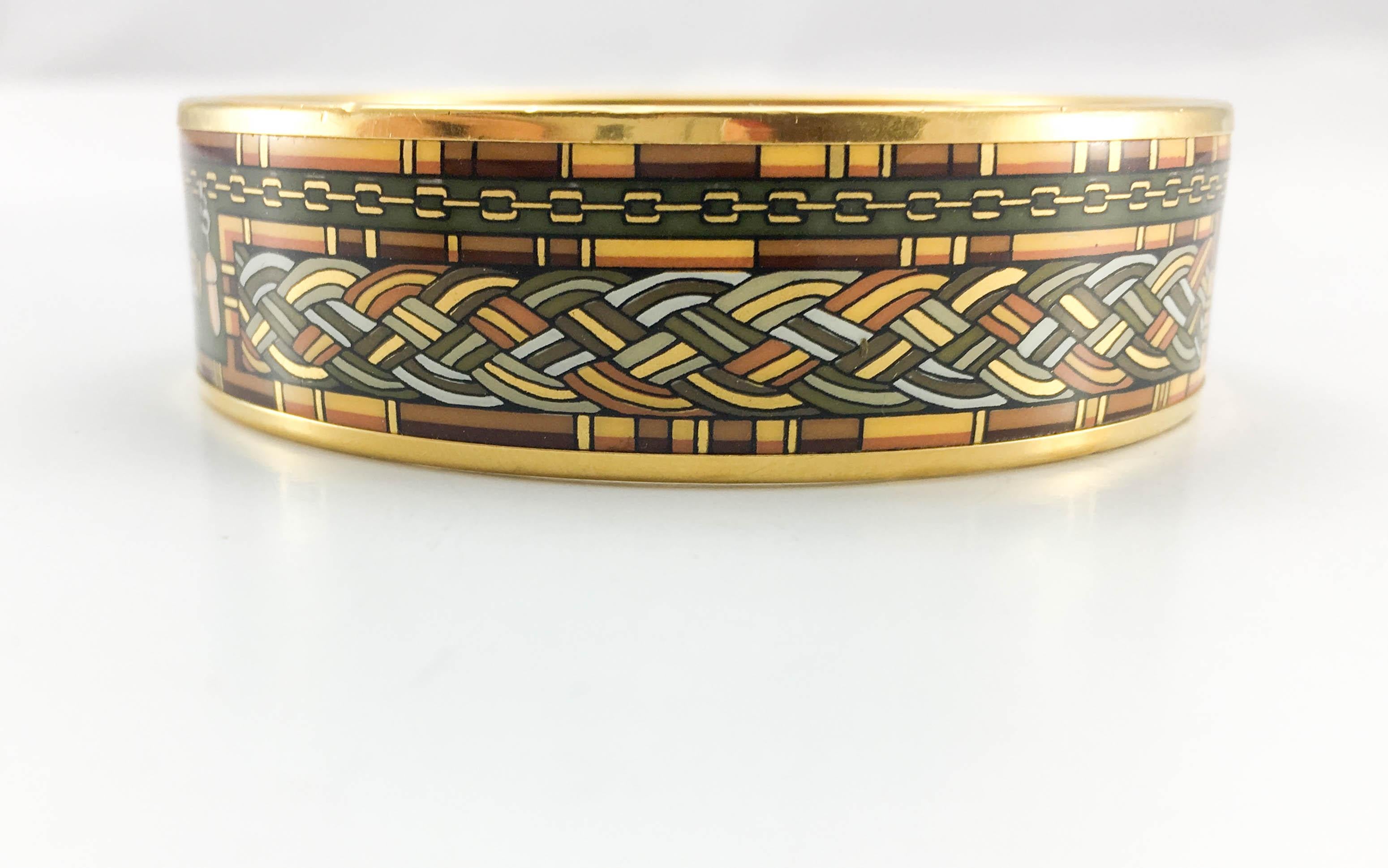 Hermes ‘Sewing Kit’ Enamel Bangle. This beautiful bangle by Hermes features a very intricated design with a sewing kit motif. Enamelled, it brings a very elegant colour palette of greens, golden and browns. Made for the chic and stylish.

Label /