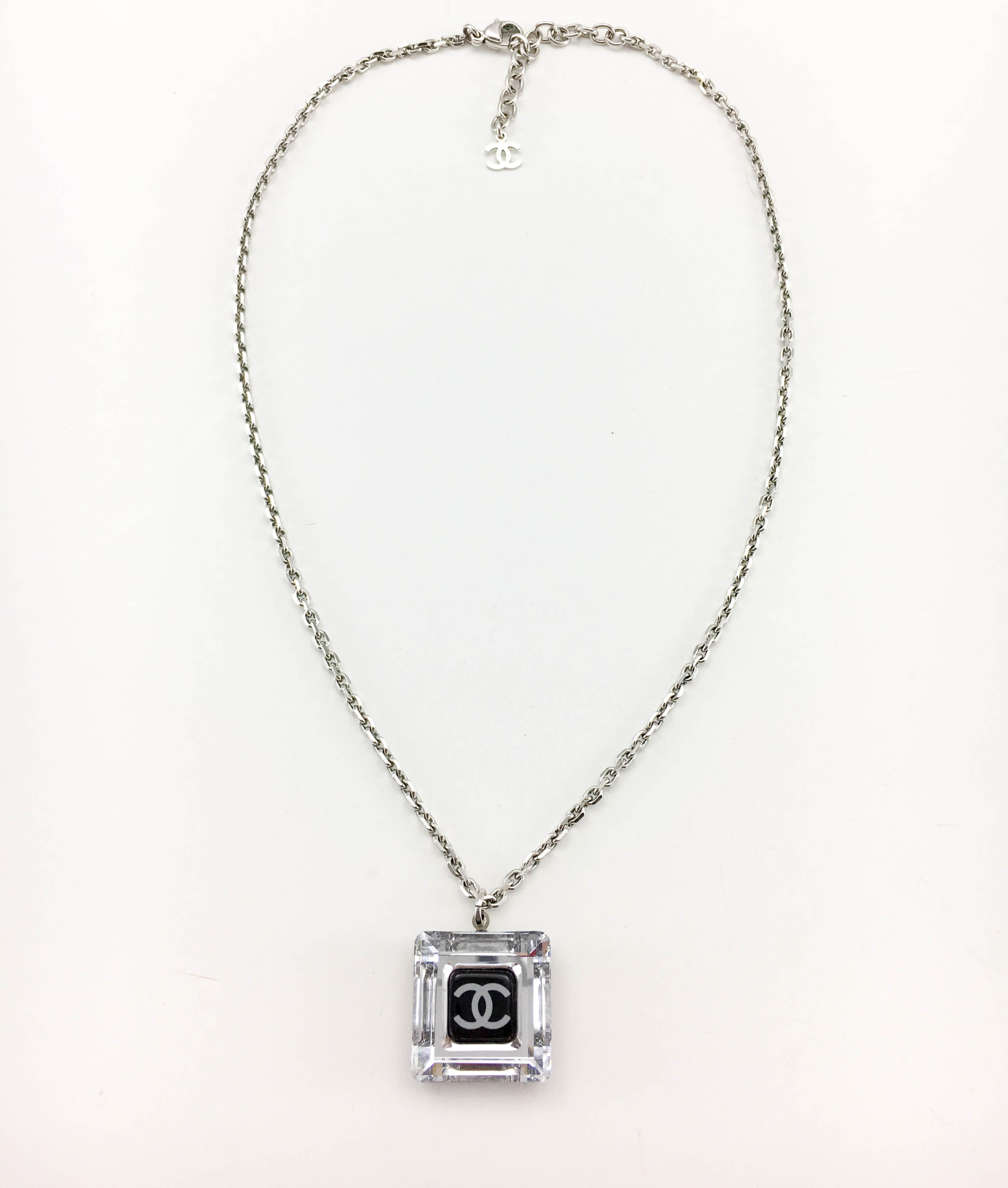 Chanel Square Logo Pendant Necklace. This beautiful necklace by Chanel were created for the 2005 Autumn / Winter Collection. Made in clear and black resin, this delicate square-shaped pendant features the iconic ‘CC’ logo in the centre. It hangs