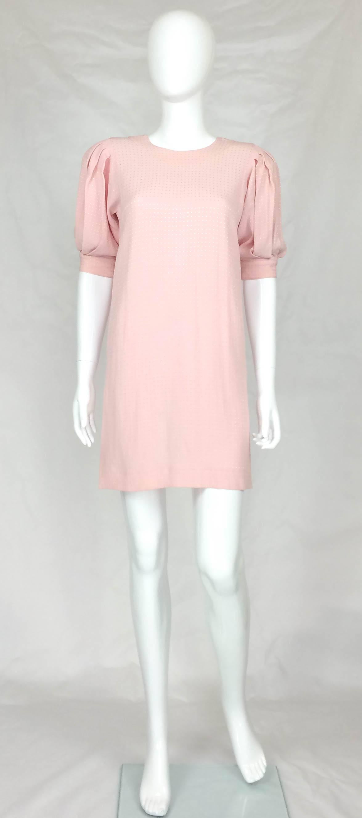 Vintage Jean Muir Mini Dress. This is a very flirty and cute pink dress by one of England’s finest designers. Candy pink colour. The fabric is textured, emulating small embroidered squares. It features a jewel neckline (crew neck) and elbow length