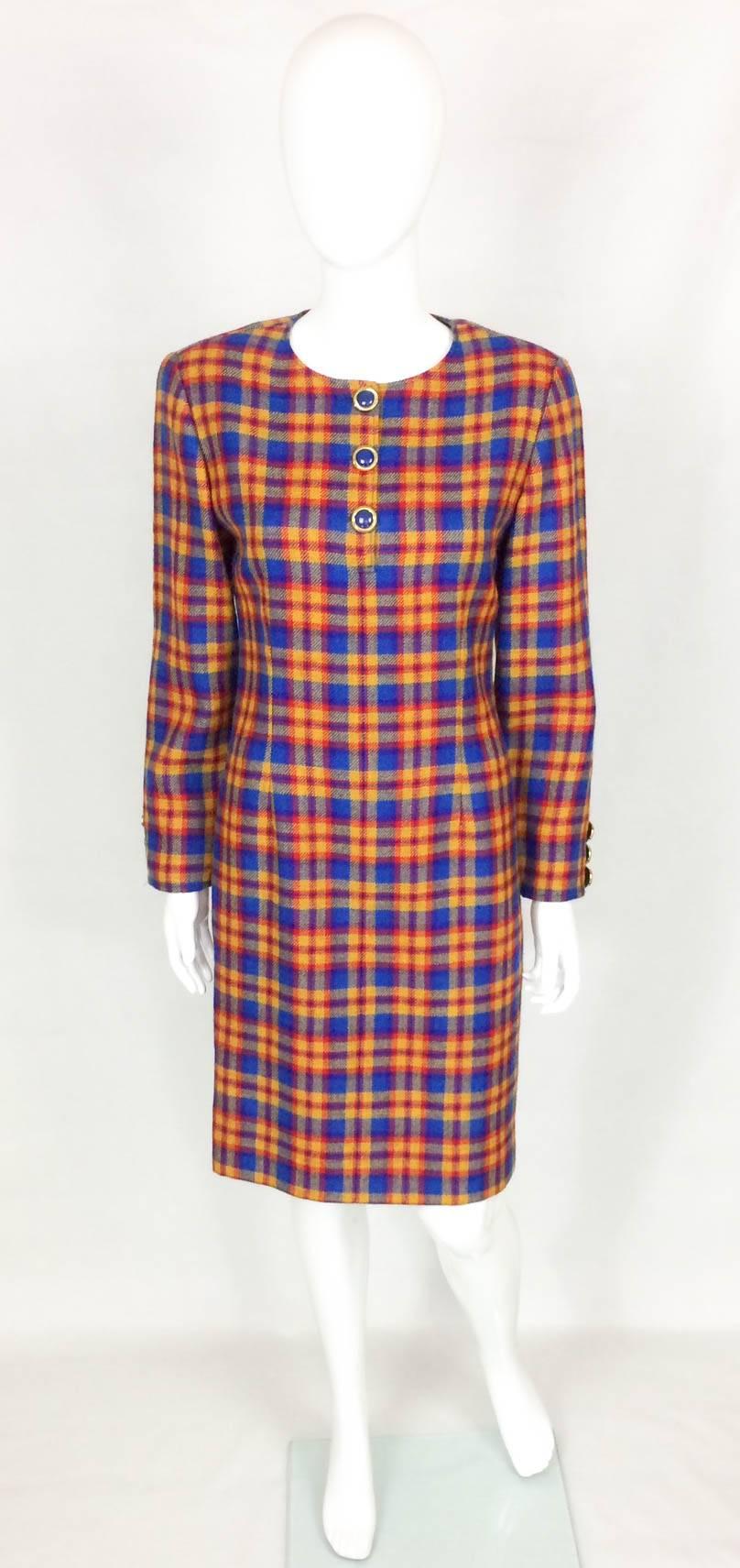 Striking Vintage Valentino Wool Plaid Dress. This great looking knee-length dress features a 3-button collar and 3-faux-button cuffs. The plaid pattern is in red, orange and blue. On the back there is an invisible zipper and a modest slit. Fully