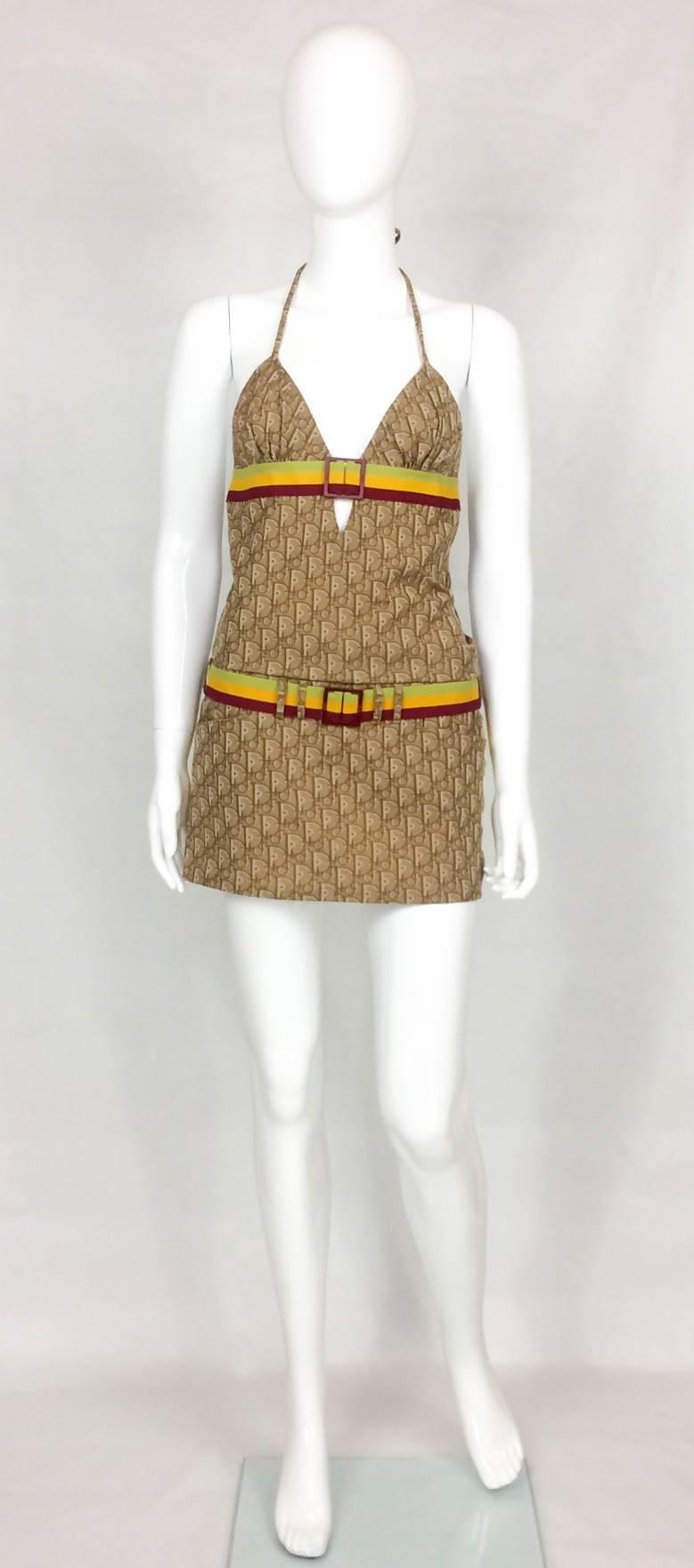 Fabulous Vintage Dior Suit. This one of a kind ensemble features a mini skirt and a top with the bust and collar resembling a bikini top, with adjustable straps. Dior-logo pattern fabric. There are 2 elasticated and colourful belts, on the waist and