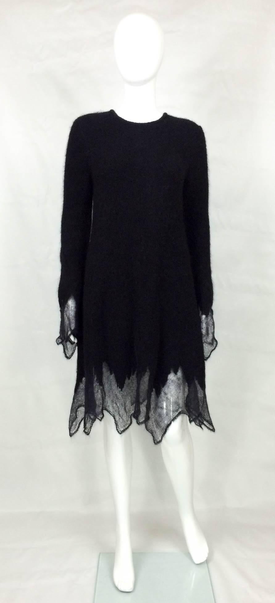 Fabulous Chanel black mohair sweater dress. This fantastic Chanel fall 2009 runway look piece has a simple pull-over design with one sparkly black button showing the Chanel logo at the back of the neck. Made of soft black mohair blend, it features