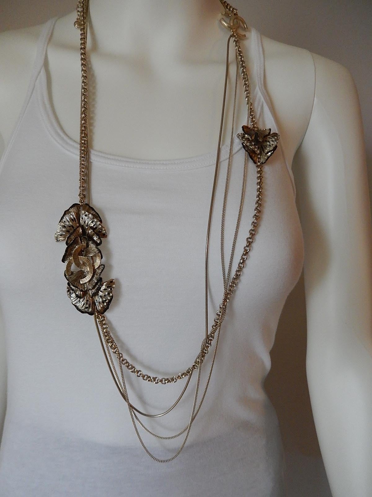 Beautiful, brand new, long multi-chain Chanel Necklace.
Each gold strand is a different link
Gold with some black and white enamel work on the butterflies
CC Large logos on either side
From 11P
Measures 21