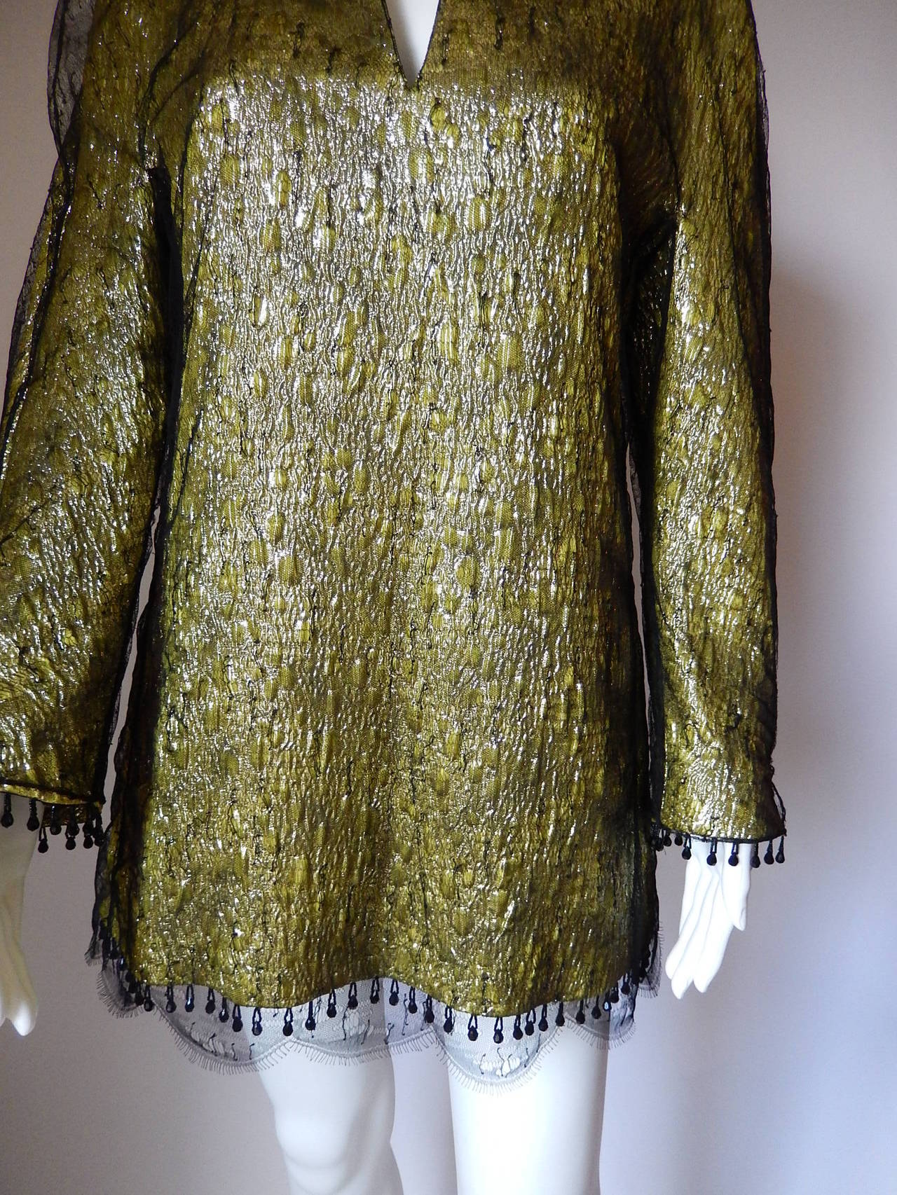 Stunning and one of a kind Chado Ralph Rucci Tunic.
Body is textured wool and silk in a green/gold color.  
Overlay is black lace with stitching details all over it.
Hanging from cuffs and hem, are black crystal polygon beads which are hanging