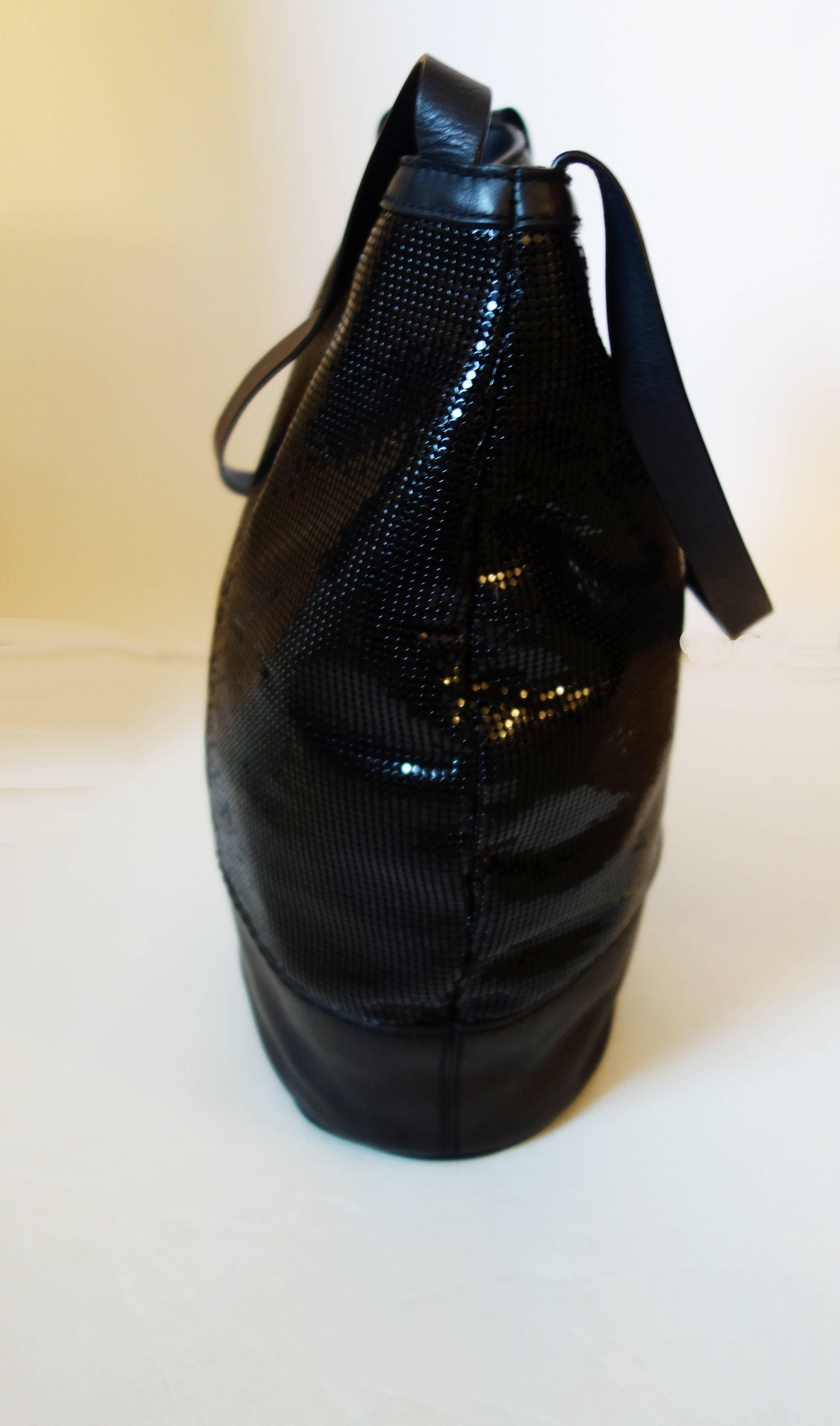 Chado Ralph Rucci Sequin and Leather Shoulder Bag
All sequins intact
Black leather a bit rippled
Four feet on bottom
Inside is suede showing a bit of wear
Two pockets inside - one with long leather pull
Measures 16