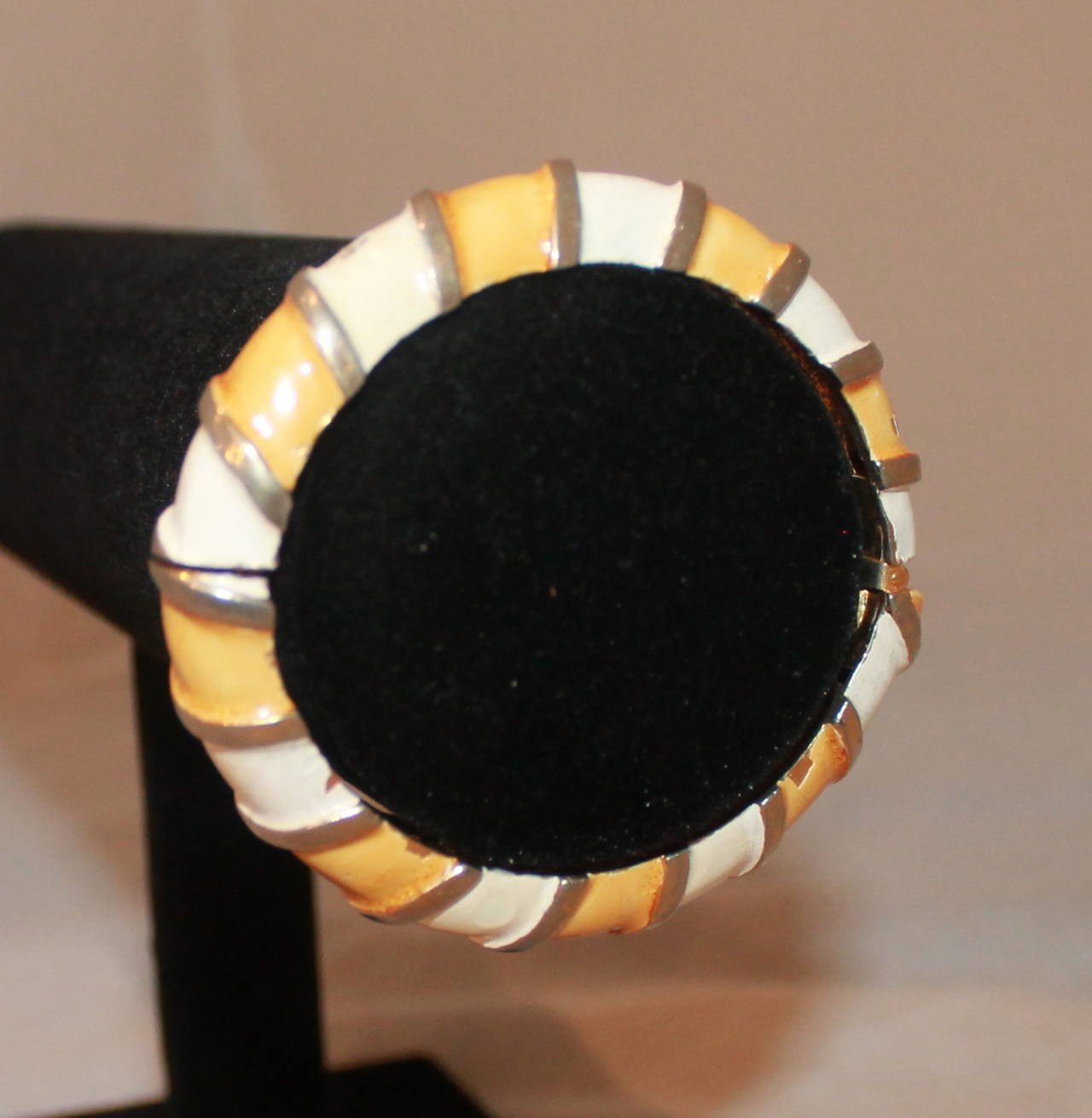 Kenneth Jay Lane Vintage White & Yellow Enamel Gold Bangle - circa 1960. This bangle is in very good vintage condition with two scuffs on the enamel. This was one of KJL's earliest pieces. 

Width- 0.35