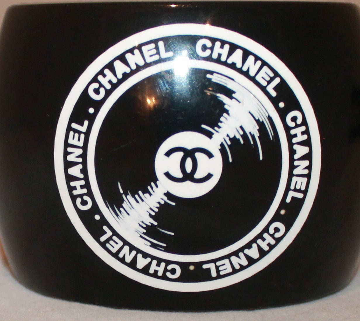 Chanel Black Record Player Collection Cuff - circa 2004. This cuff was a limited time piece and is now a collector's item. It is in excellent condition.

Width- 2.25