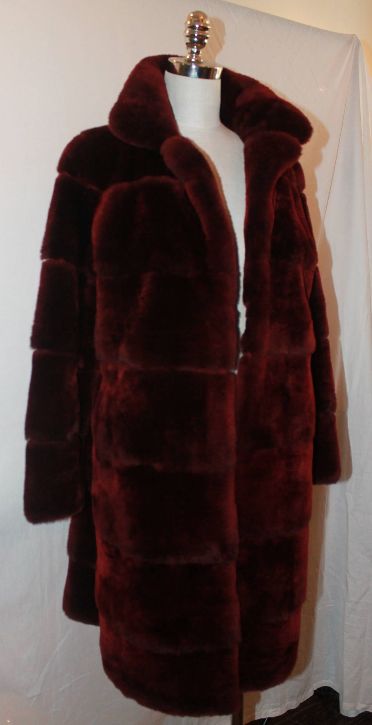 Olivia Preckel Burgundy Beaver Fur Coat - New - M. This coat has never been worn and has clips & pockets. 

Measurements:
Bust- 40