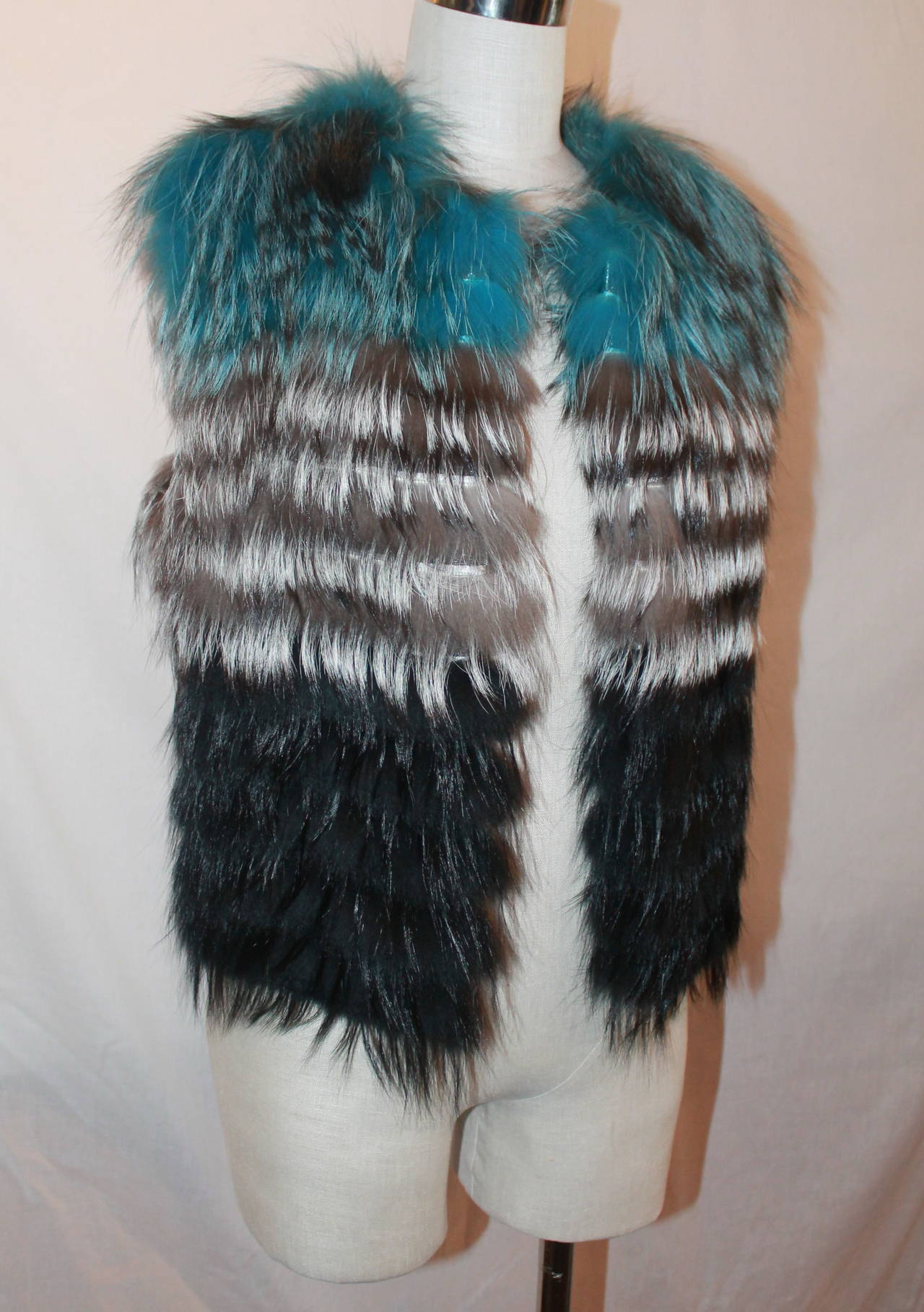 Olivia Preckel Blue, Grey, Black Fox Fur Vest - M - New. This vest has never been worn and has a layered color look. The vest has hooks. 

Measurements:
Bust- 37