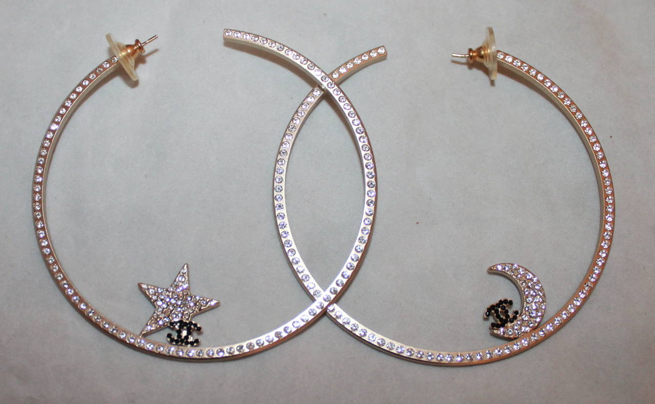 Chanel Large Star & Moon Rhinestone Hoops - circa 2000. These hoops are in mint condition and come with the box.

Length- 3