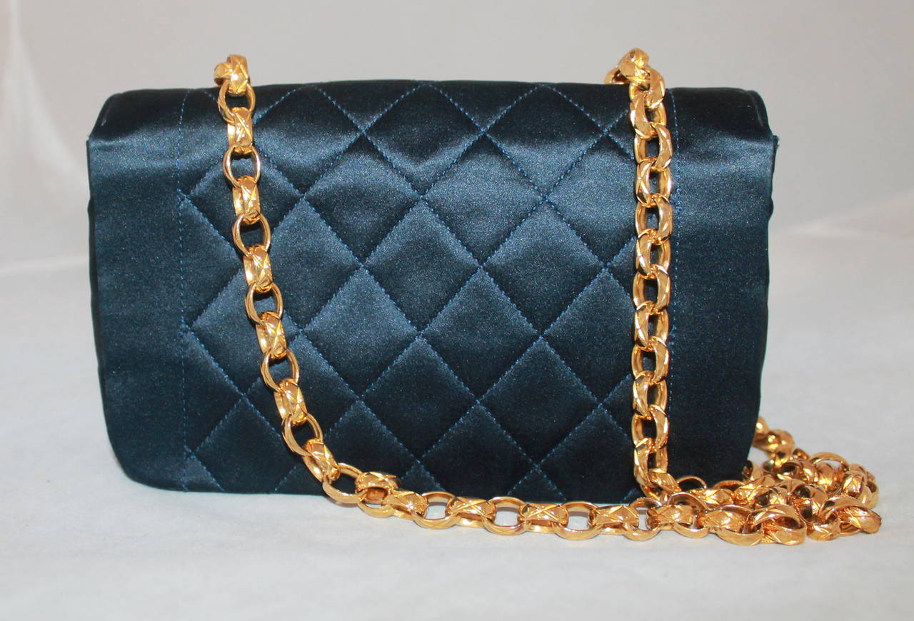 Chanel Vintage Navy Silk Quilted Small Classic Handbag - circa 1990. This handbag is in excellent condition and comes with a duster.

Measurements:
Length- 4.75