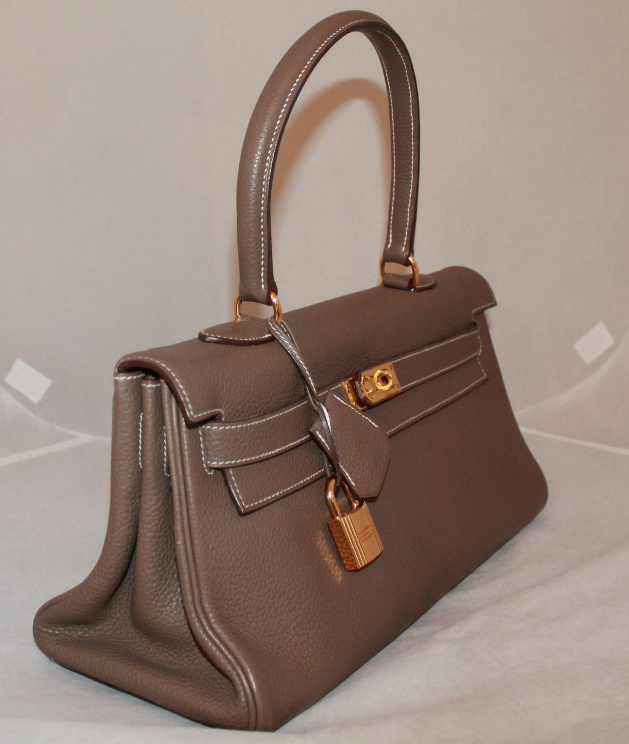 Hermes Etoupe Togo JPG II Shoulder Birkin GHW - circa 2009. The leather on this bag is in excellent condition, but the hardware on the front is scratched. It should be able to be buffed out if taken to Hermes for the spa treatment. Comes with duster