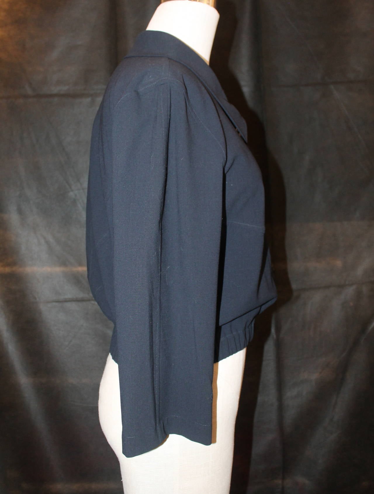 Chanel Navy Wool Jacket/Shirt with Elastic Bottom - 38. This shirt is in good condition with minor wear. There is a matching maxi skirt in stock. 

Measurements:
Bust- 38