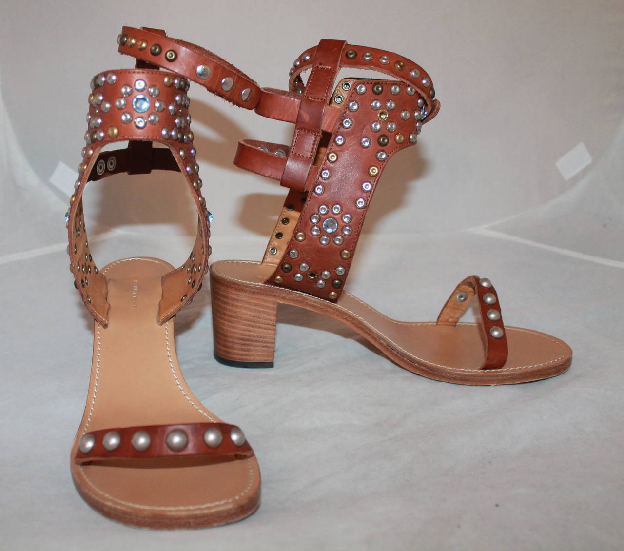 Isabel Marant Leather & Cap Embellished Sandals - 41. These sandals are in excellent condition with the only signs of wear being on the bottom sole. They come with the box & 2 dusters. These shoes retail for $1035.00