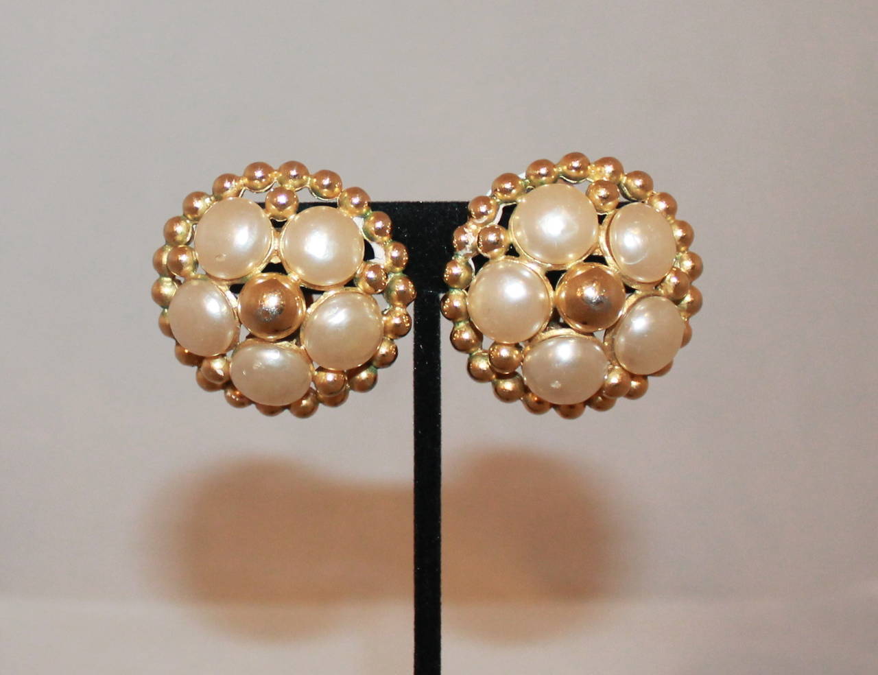 Chanel Vintage Goldtone Flower Pearl Clip-On Earrings - circa 1988. These earrings are in good vintage condition with some signs of wear. The back of the earrings has some greening on the gold. 

Length- 1.5