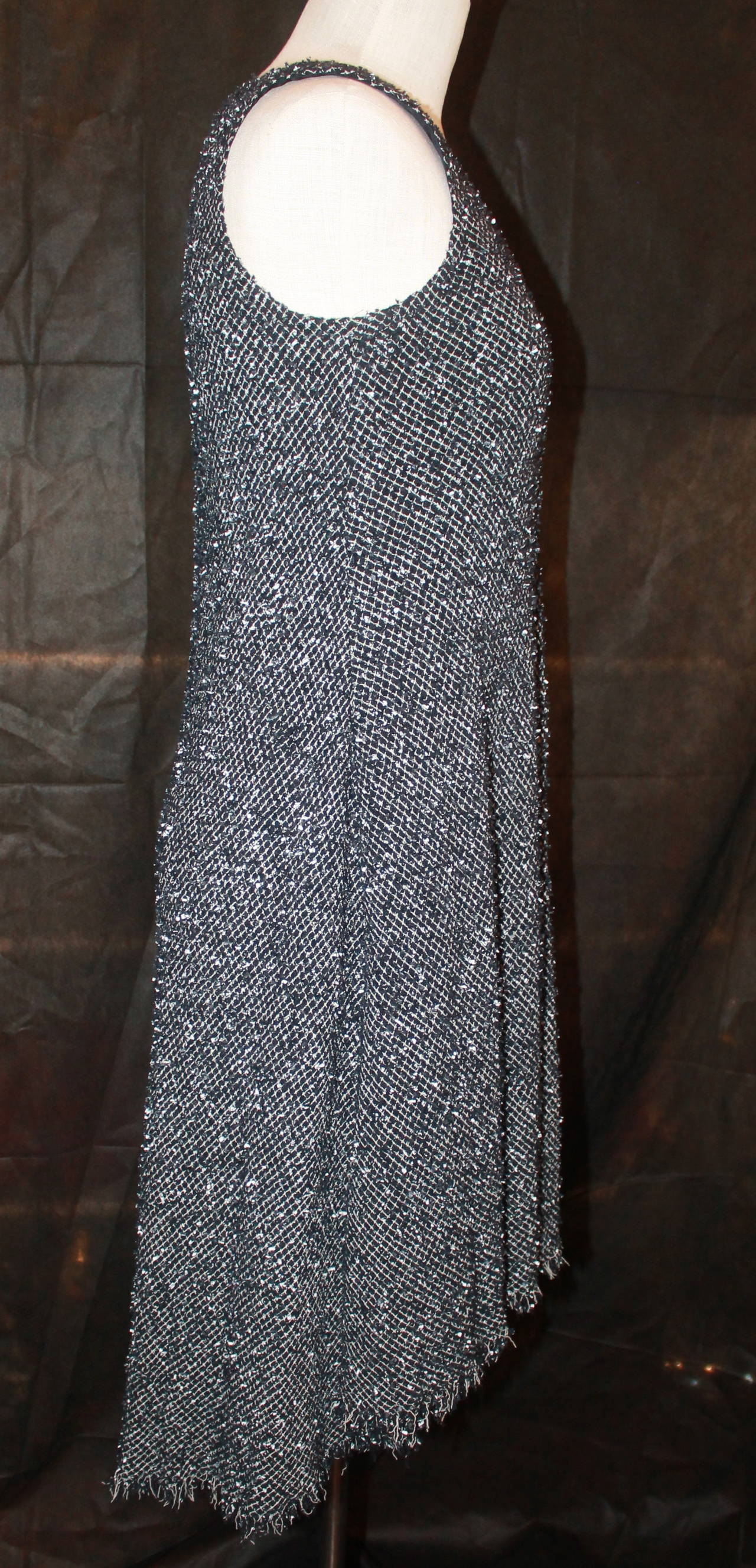 Chanel Black & White Tweed High-Low Dress - 38. This dress is in excellent condition and has a shift style. It also has a camellia button accent in the back.

Measurements:
Bust- 29