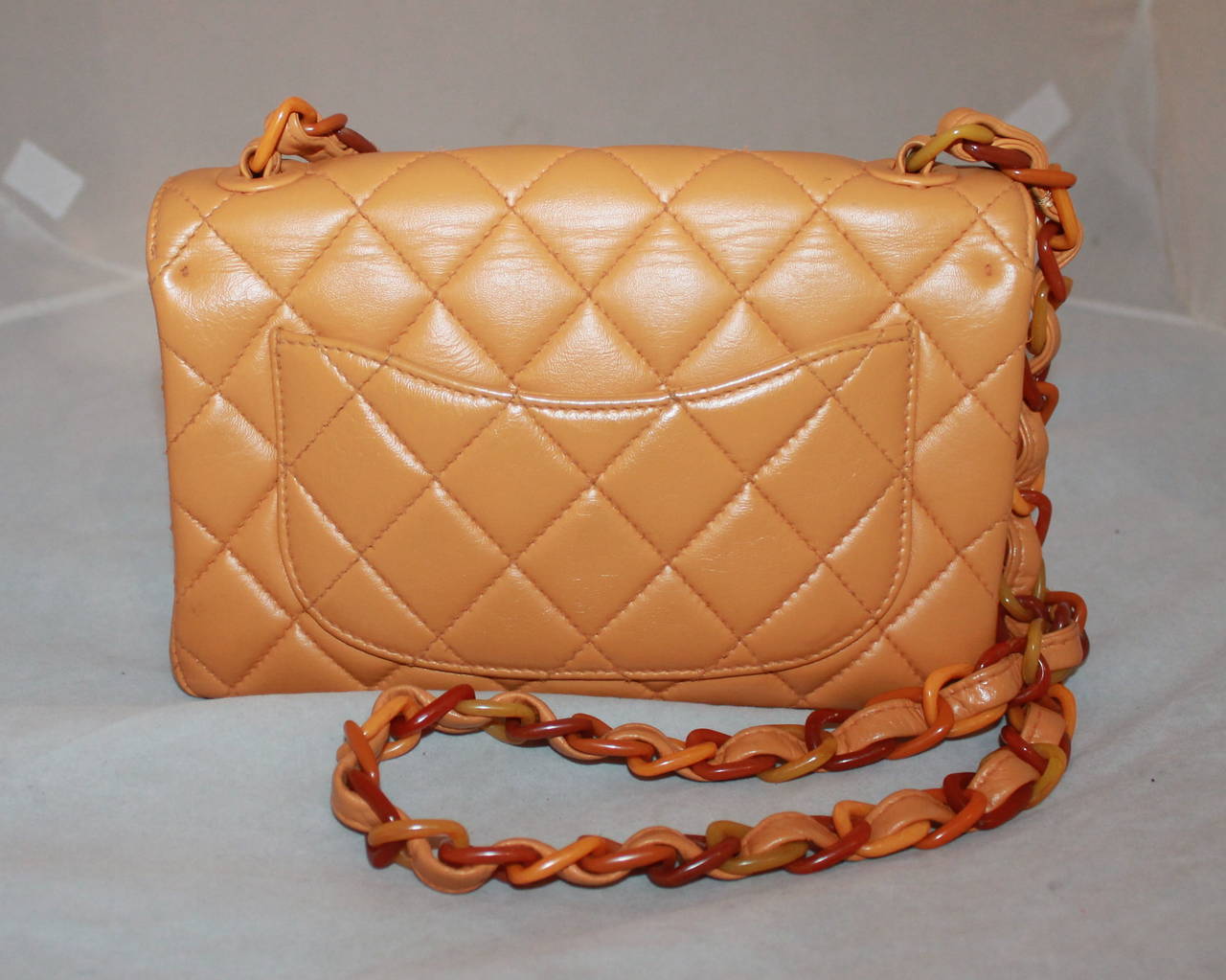 Chanel Vintage Mustard Lambkin Quilted Handbag with Bakelite Chain - circa 1998. This handbag is in very good vintage condition. 

Measurements:
Length- 6.75