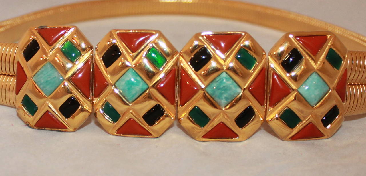 Judith Leiber Vintage Golden Stone Stretch Belt. This belt is in excellent condition and stretches to different sizes. The belt hooks on and off and has turquoise tone, amber, and green stones. 

Length- 31.5