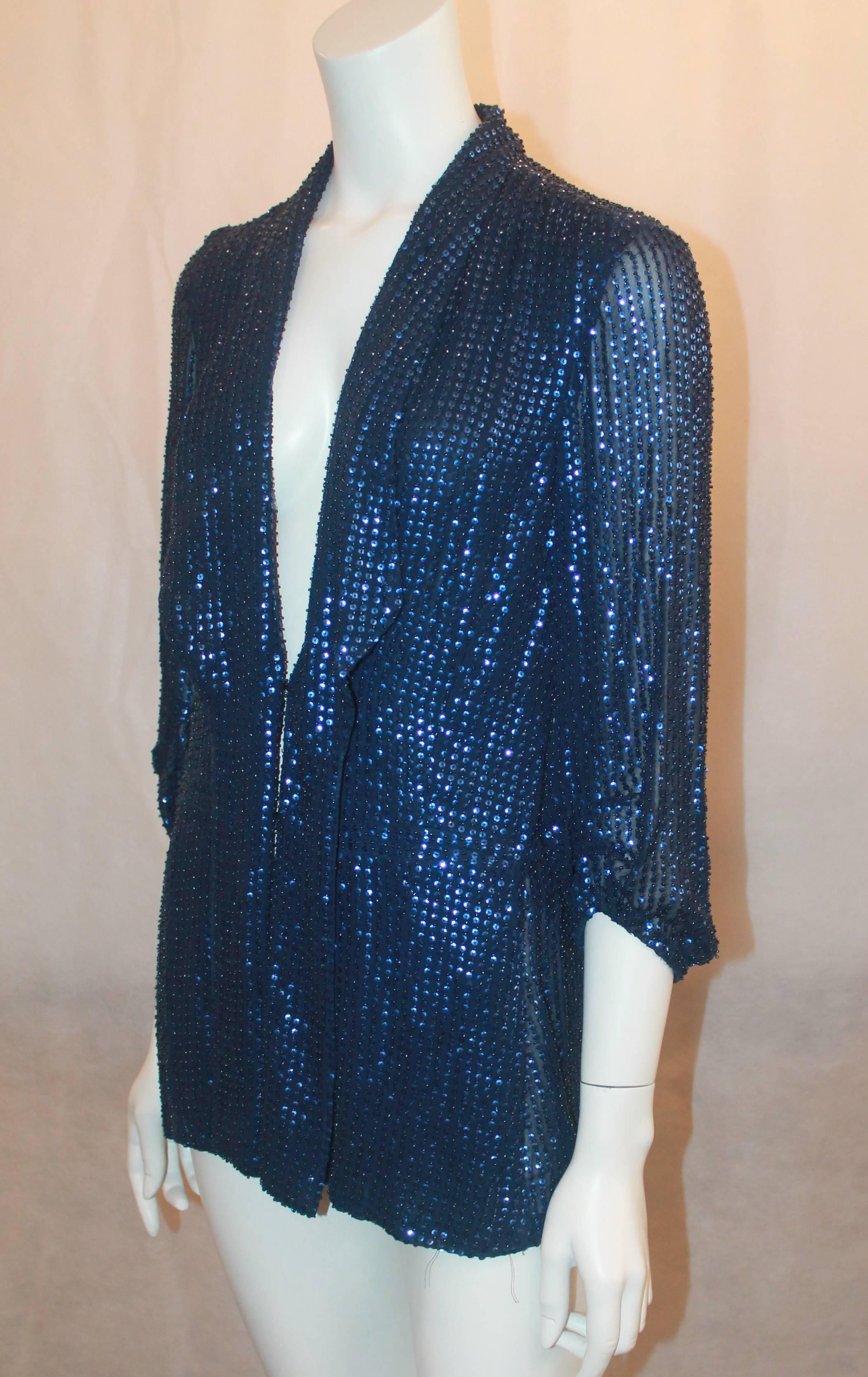Diane Von Furstenberg Blue Sequin Loose Blouse - 6. This blouse is in very good condition and is a unique, gorgeous piece. The main tag is gone and there is a small hole in the fabric by the left shoulder. It features cinched sleeves, pleats along