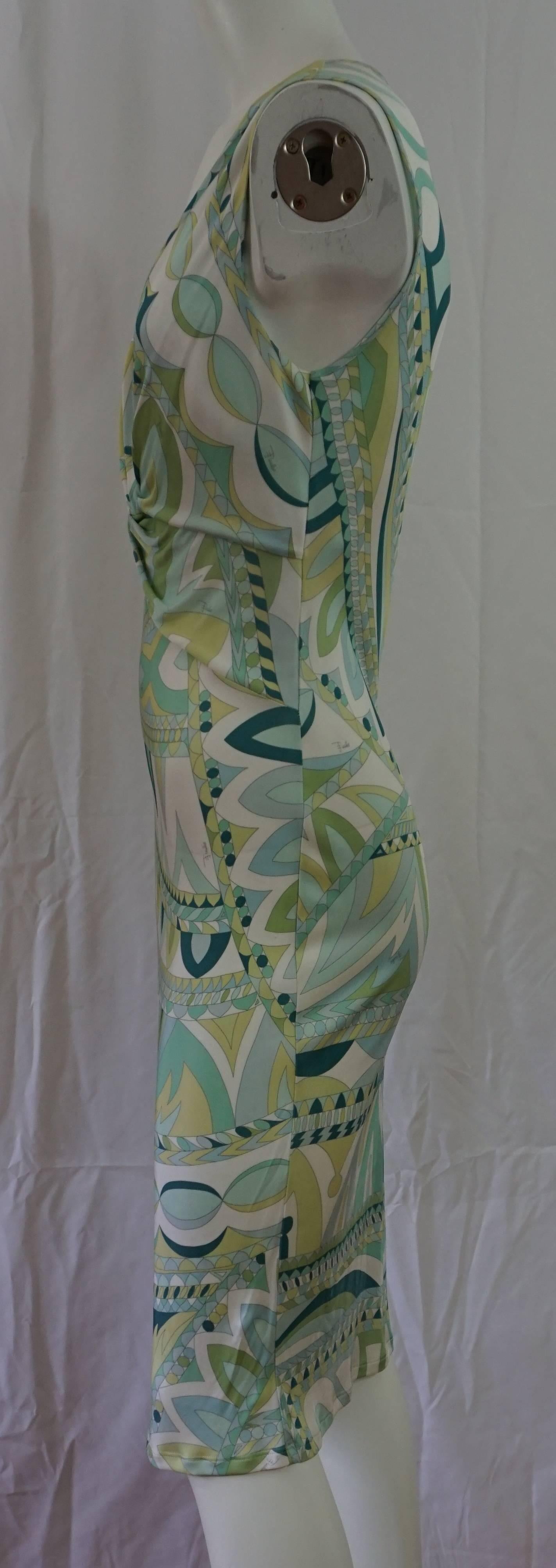 Emilio Pucci Greentone Print V-neck Sleeveless Dress - 12  This beautiful sleeveless V-neck dress has a silk jersey feel and a multi green print. There is a knot look with some ruching meeting at the V-neck. This dress is in very good