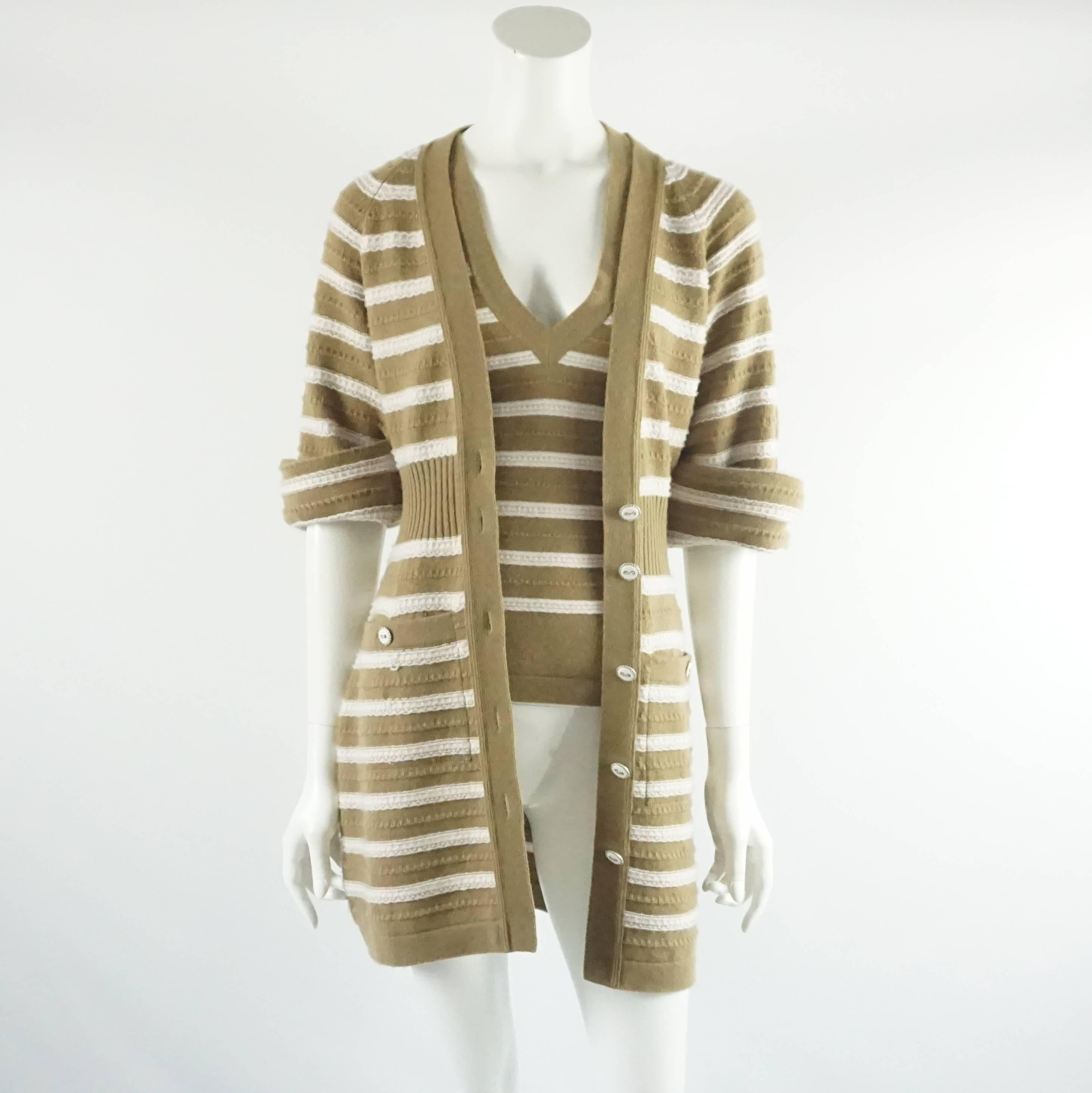 This classic Chanel set is a striped camel and ivory cashmere. The set comes with a sweater dress that can be worn both ways. It has a textured fabric, cinched waist, ivory enamel buttons, 2 front pockets, and rolled sleeves attached with a stitch.