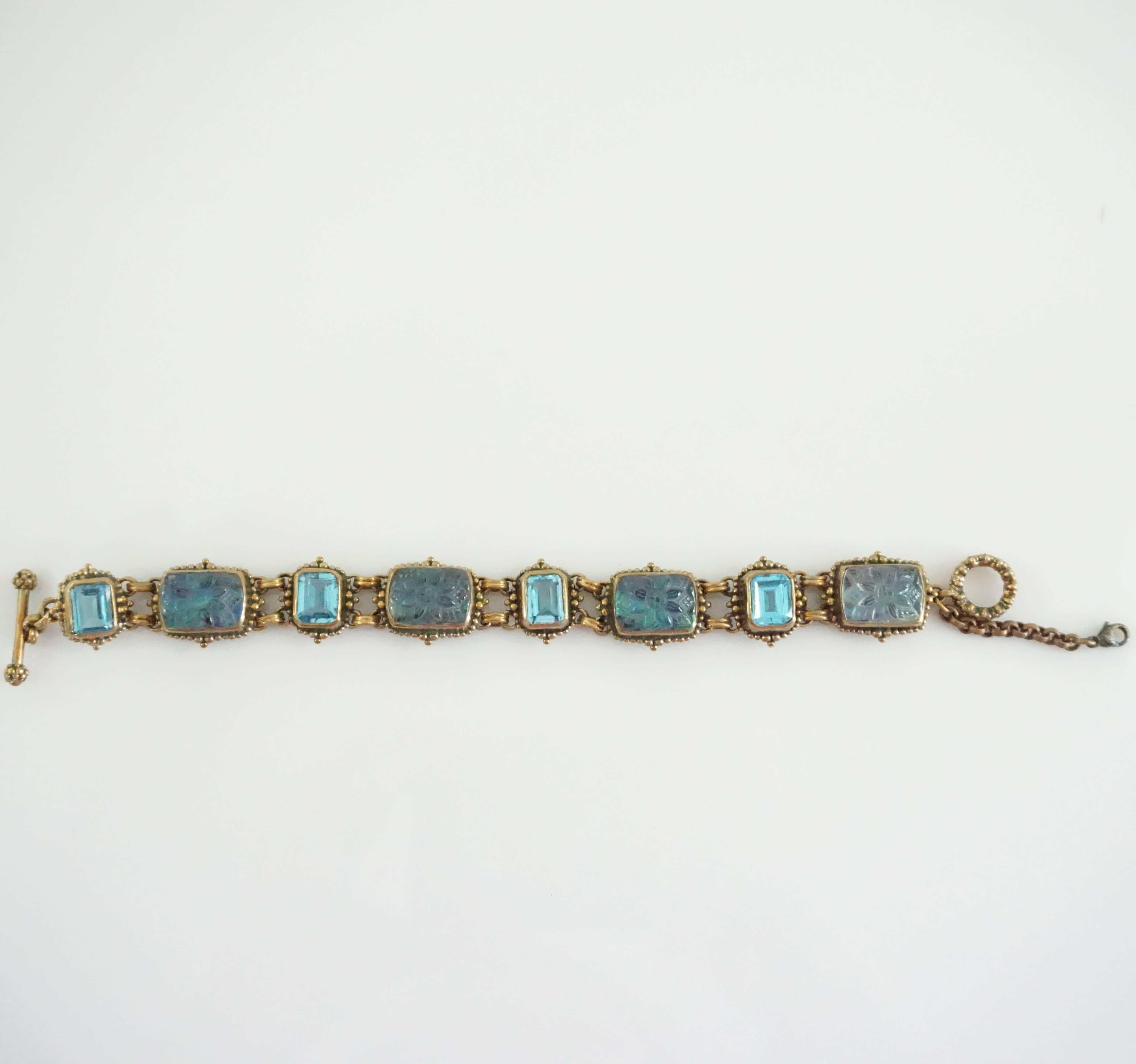 This beautiful Stephen Dweck bracelet from the 2001 collection has blue crystals in different shades of blue. The chain is bronze and textured with a toggle closure. This bracelet is in excellent condition and never has been