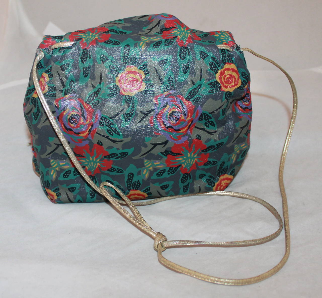 Carlos Falchi 1970's Green Floral Print Leather Crossbody Bag. This bag is in very good vintage condition with wear consistent to its age. The strap can be adjusted by tying the knot higher & lower. 

Measurements:
Length- 8.5