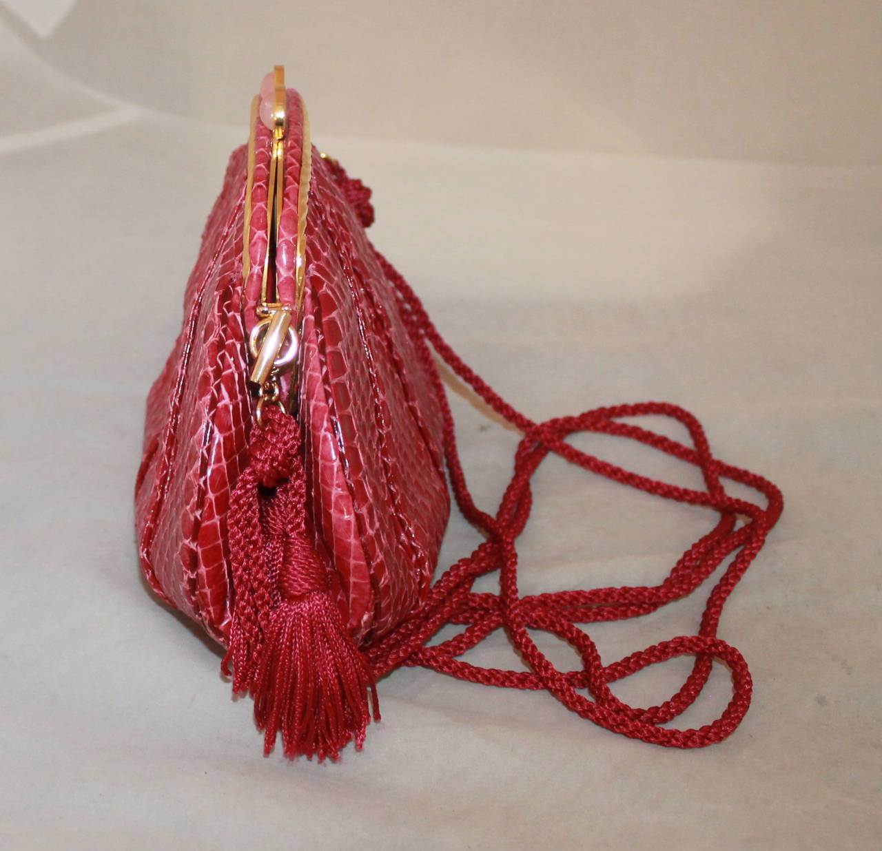 Judith Leiber Vintage Rasberry Snakeskin Evening Bag with Rope Handle. This bag is in excellent condition with the duster, coin purse, comb, and cards. 

Measurements:
Length- 5