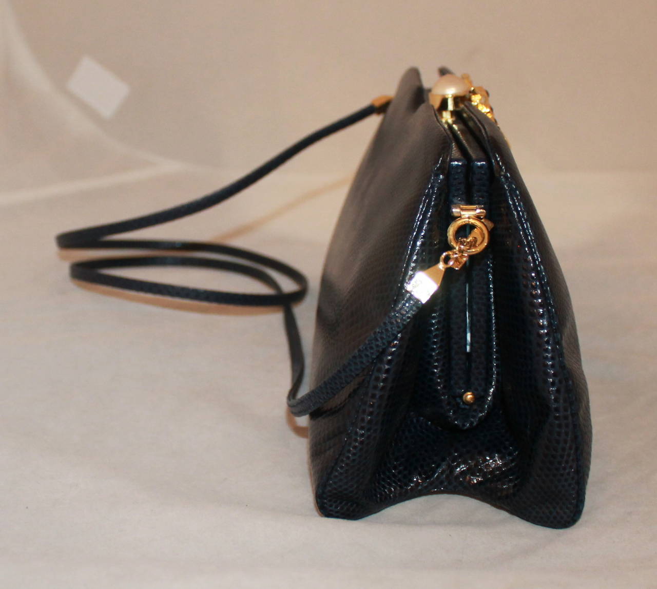 Judith Leiber Vintage Navy Lizard Evening Bag with Pearl & Stone Clasp. This bag is in excellent condition and comes with the coin purse, duster, and cards. 

Measurements:
Length- 4.75