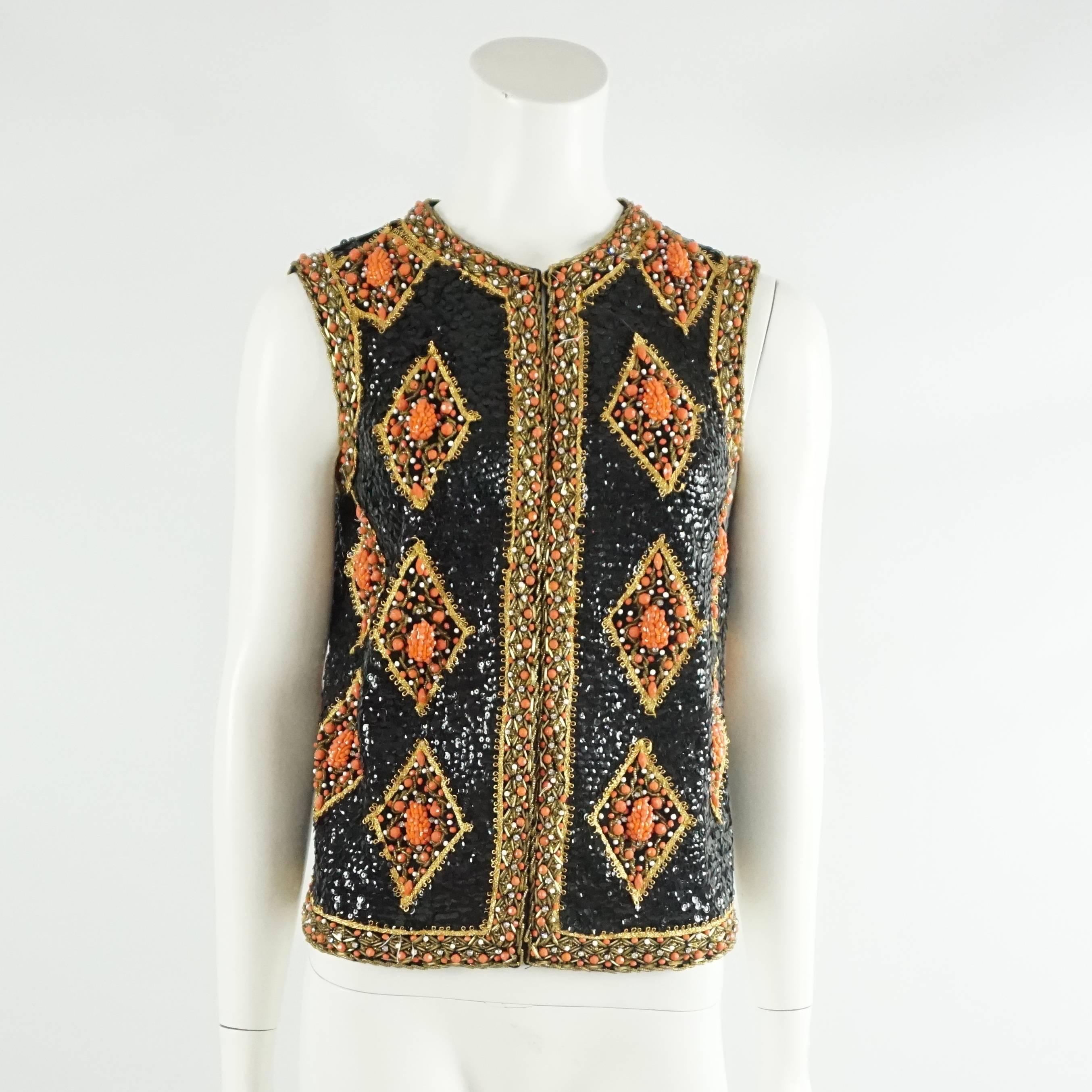 This gorgeous Saks Fifth Avenue vintage fully beaded vest is a rare find. It is covered with black beads and has a diamond print all over with a orange and gold trim around. The vest shuts with hook and eye closures along the front. The vest is in