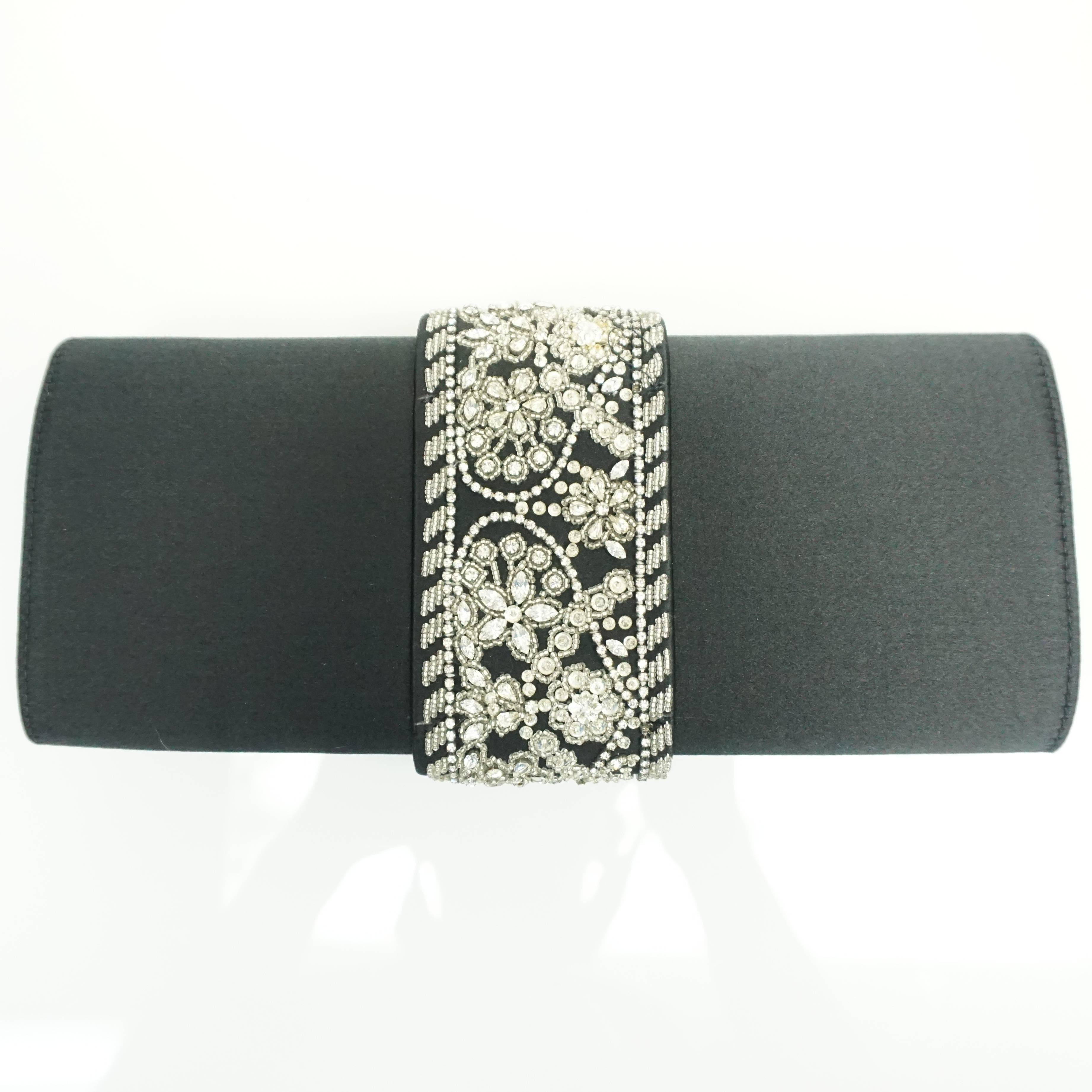 Oscar de la Renta Black Satin Clutch with Rhinestone Detail  This beautiful foldover clutch is made of black satin and has a 2.5
