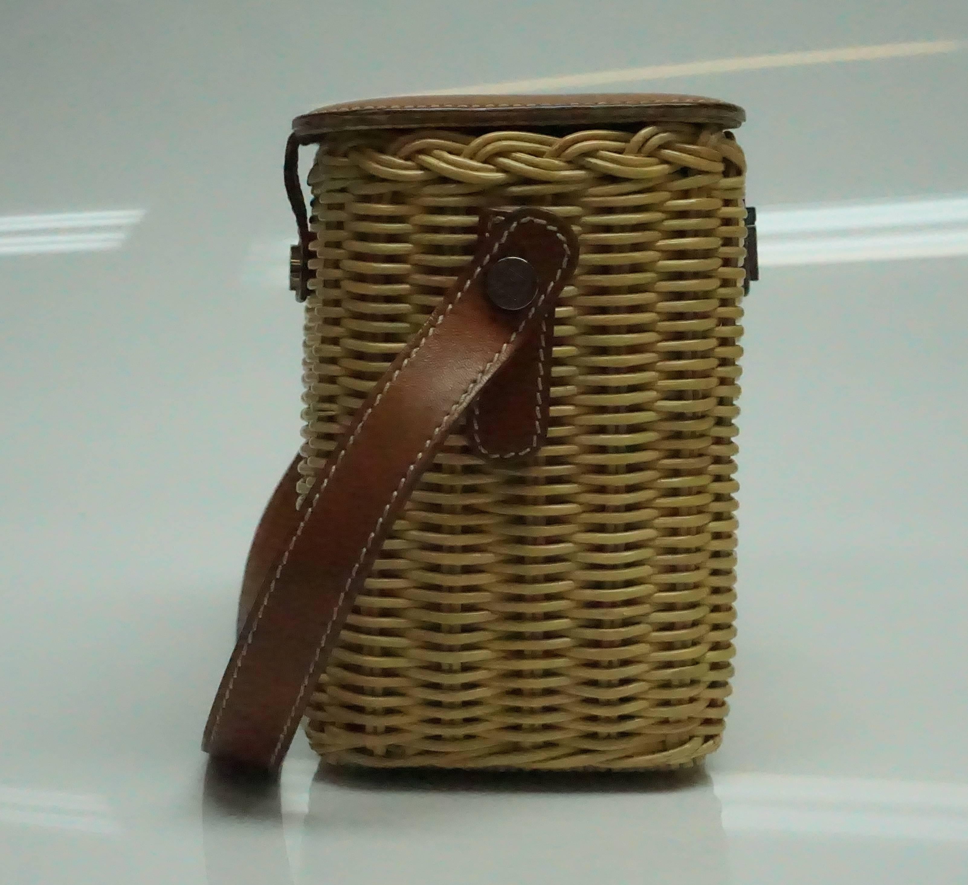 Lambertson Truex Wicker and Brown Leather Handbag. This adorable wicker bag by Lamberston Truex is in good condition. The inside material shows some fading and slight staining throughout and the silver hardware shows some scratches and scuffs. The