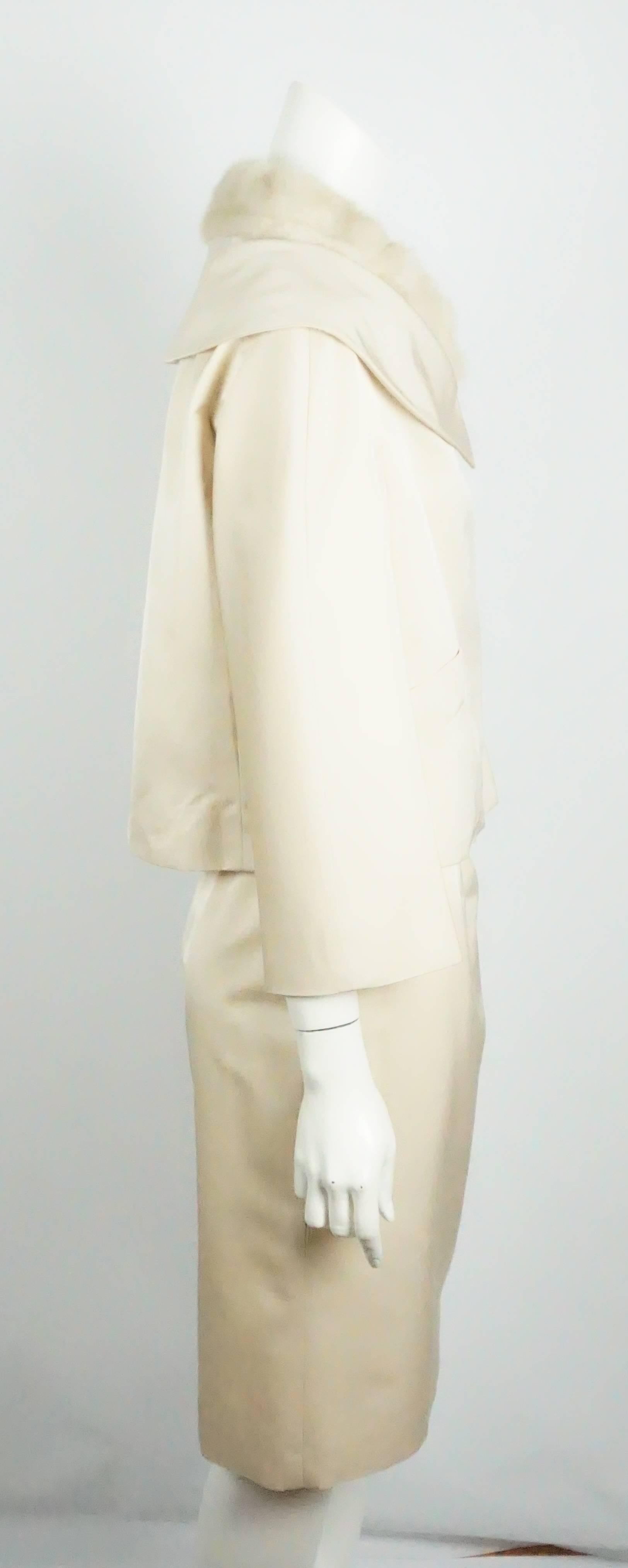 Christian Dior Ecru Silk Skirt Suit with Mink Collar - 38 - NWT  This oh so chic skirt suit is a must have. The ecru silk skirt suit has a non detachable blond mink collar that sits on top of a portrait collar. The suit is fully lined in silk. The