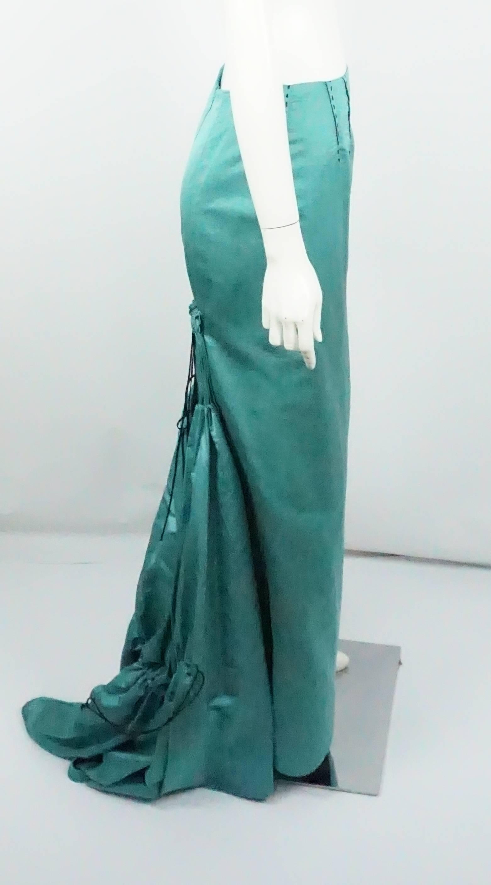 Carolina Herrera Teal Silk Faille Long Skirt - 6 - NEW  This beautiful teal silk faille maxi evening skirt is fitted along the front with 4 tucks in the front with black silk ribbon stitching detail, it has a back zipper. The back of the skirt has a