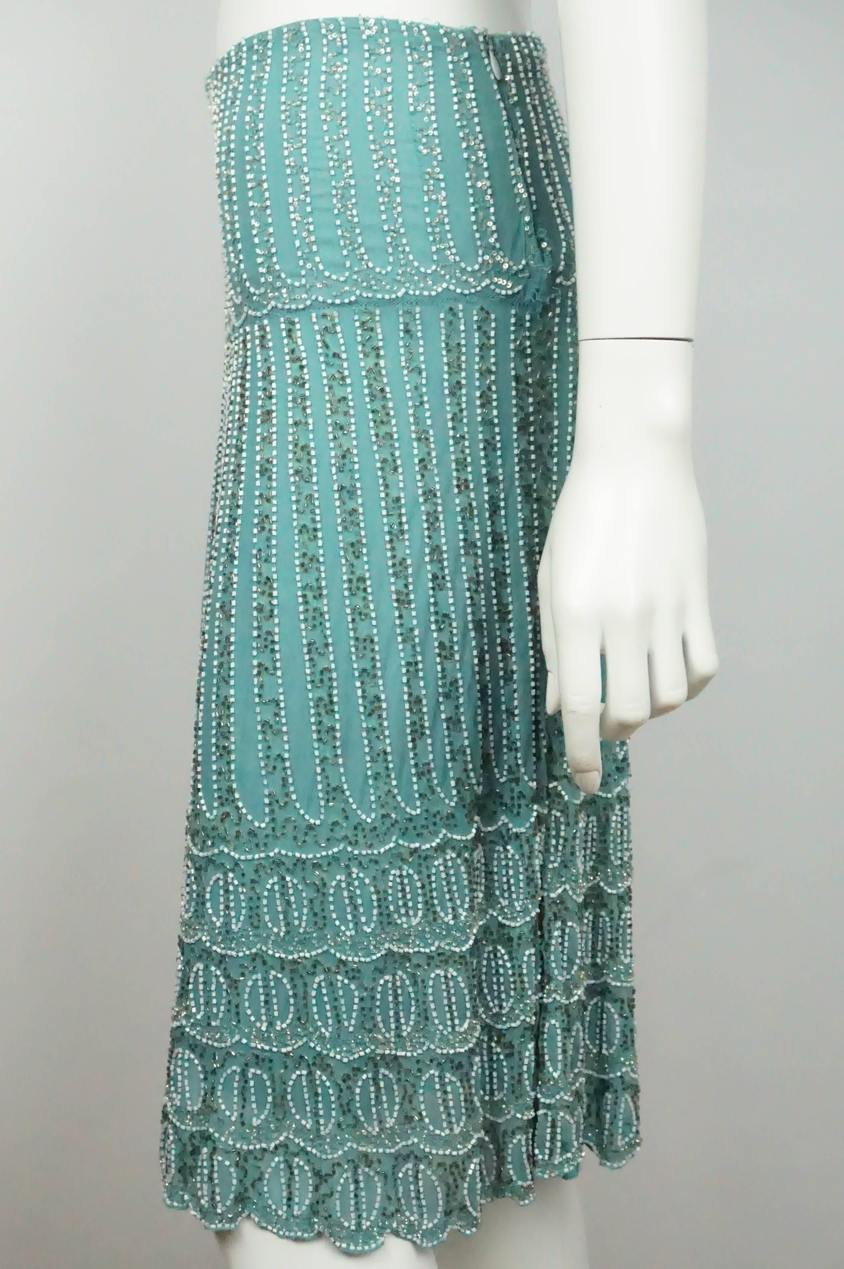 Bluemarine Turquoise Silk And White Beaded Skirt - 40  This stunning vintage beaded swing skirt is in excellent condition. The skirt is completely embellished with white and silver beading and gold sequins. The skirt is completely made of silk and