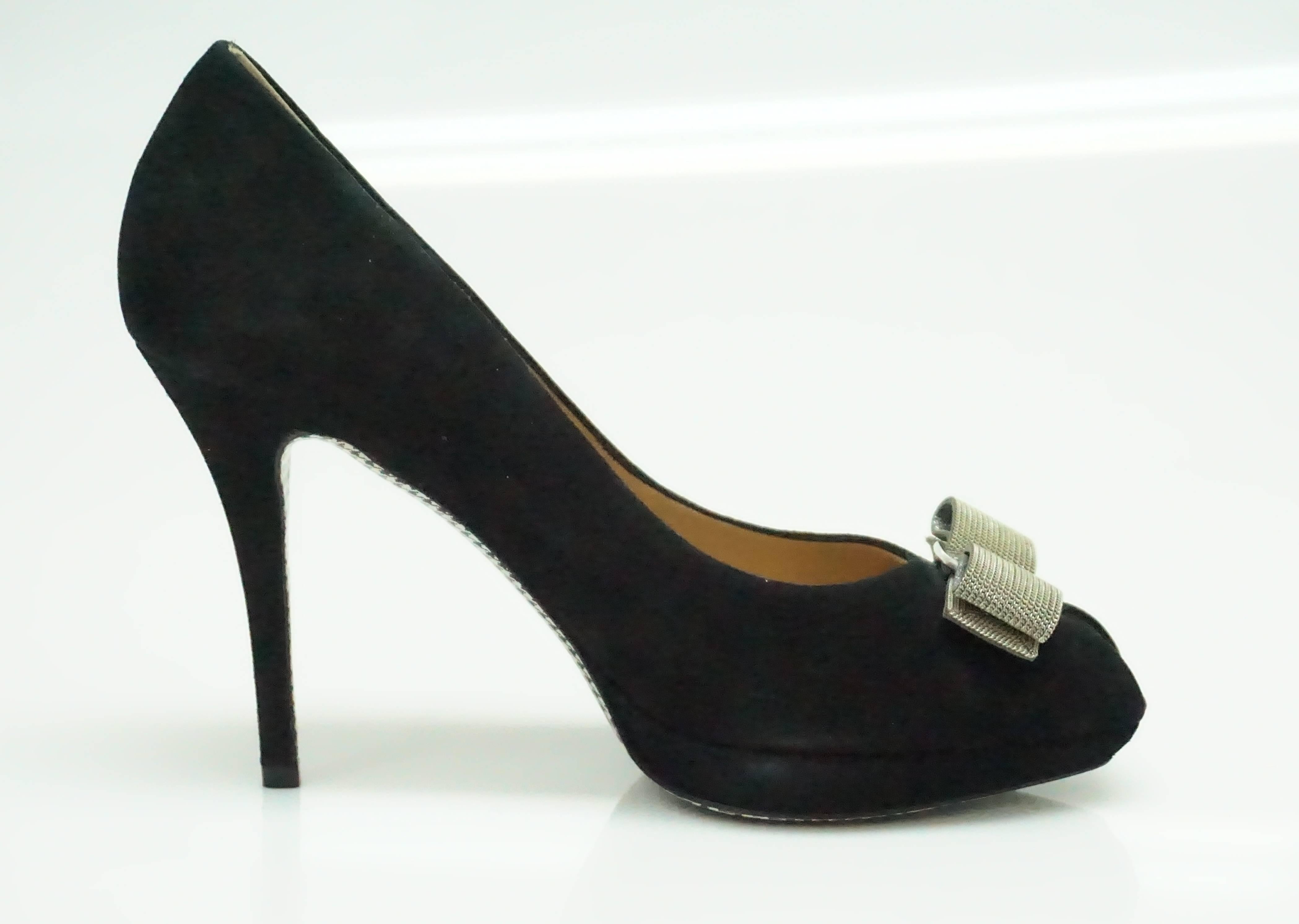 Salvatore Ferragamo Black Suede w/ Silver Mesh Bow Pump - 9  These classic heels are in excellent condition. They have probably only been worn once. The entire shoe is made out of suede and the bottom of the shoe has a houndstooth pattern. There is